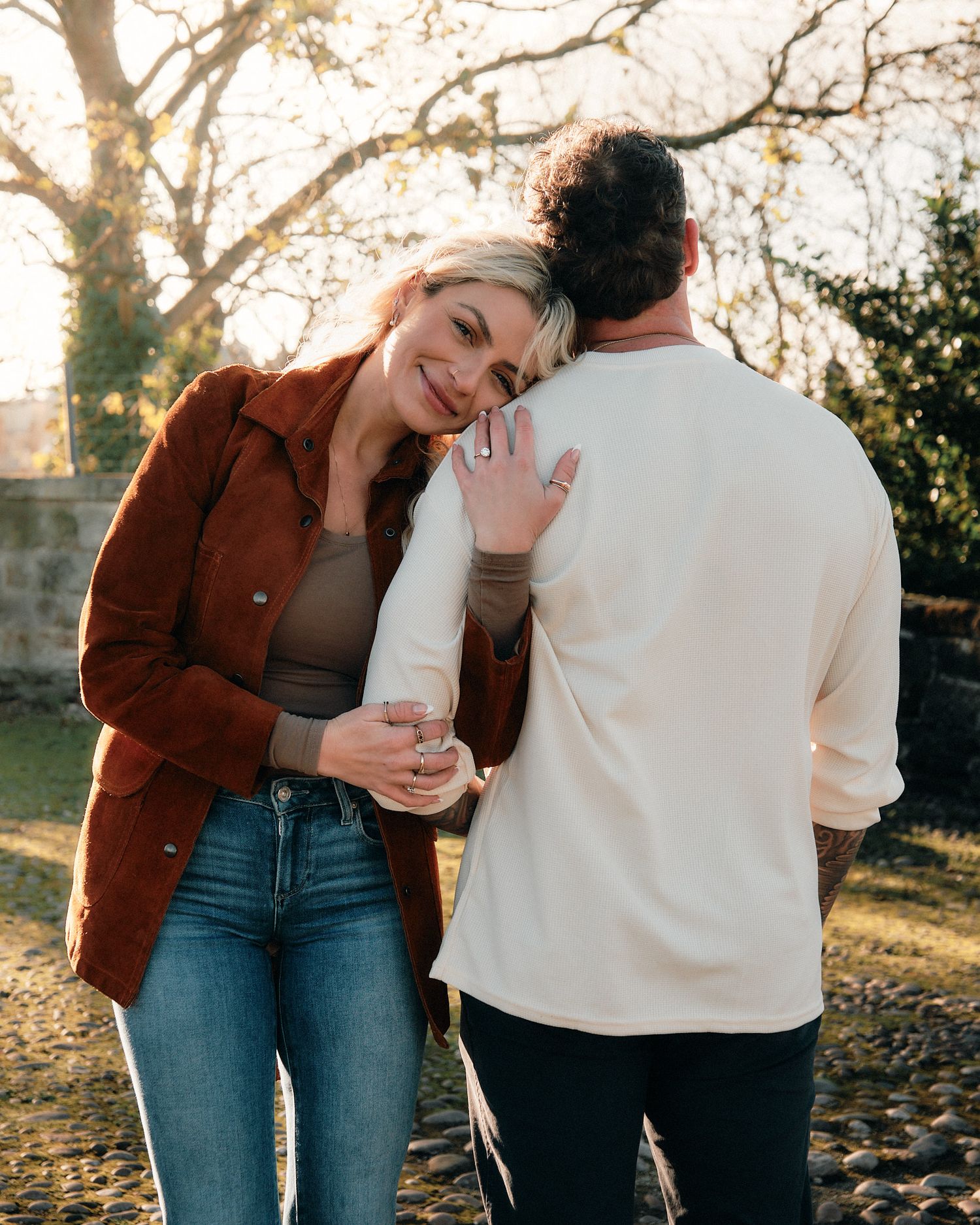 Casual outdoor couple photoshoot with warm autumn lighting and natural backgrounds.
