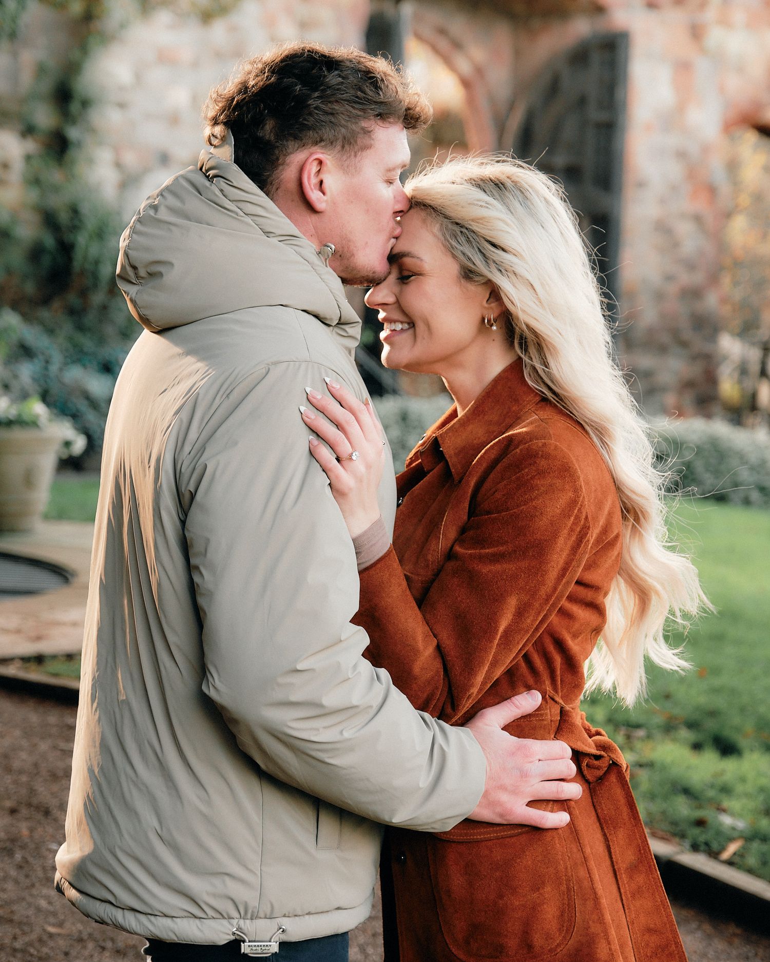 A romantic couple embraces outdoors wearing fall clothing in a series of candid moments.