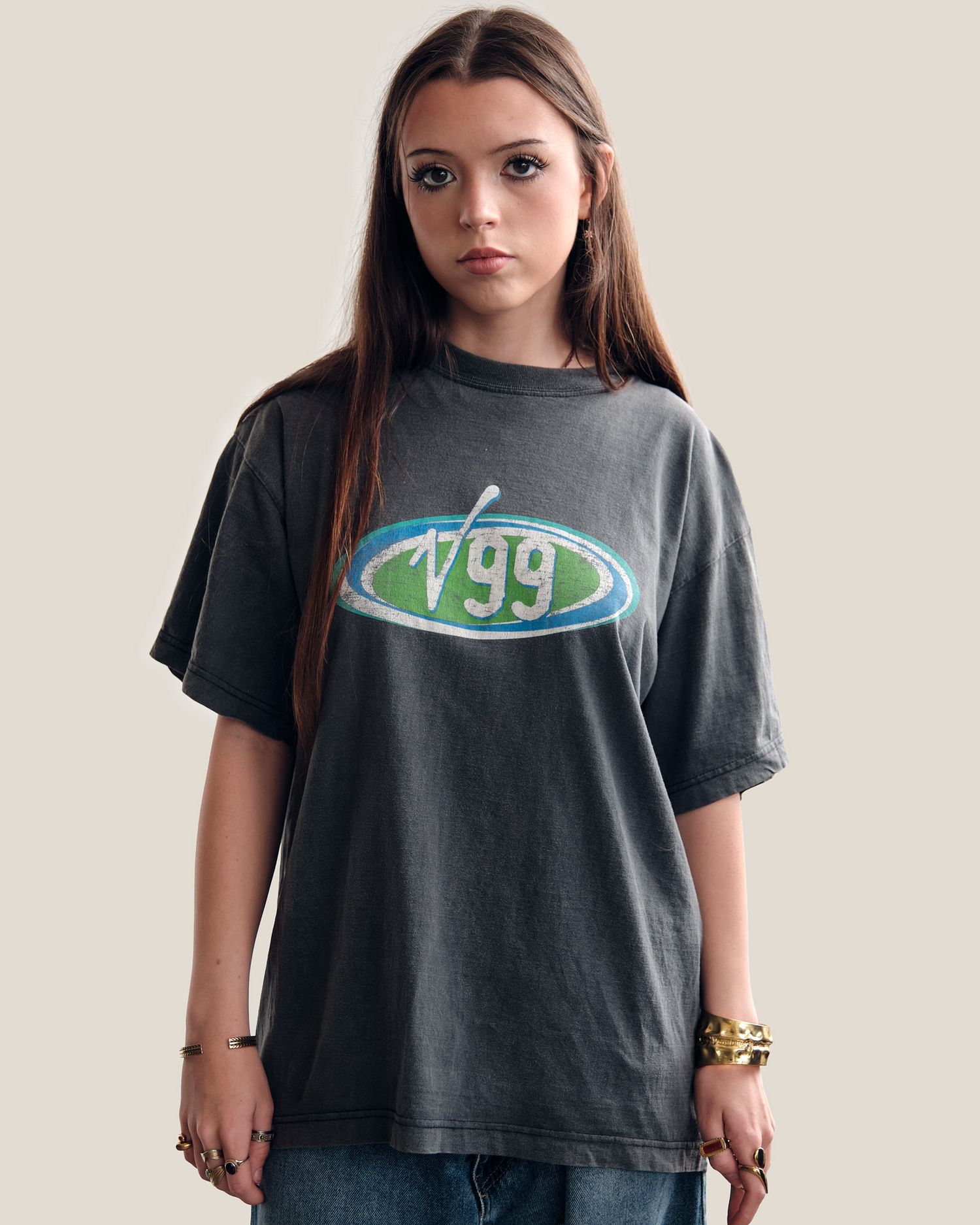 Person wearing a black t-shirt with green logo against light background.