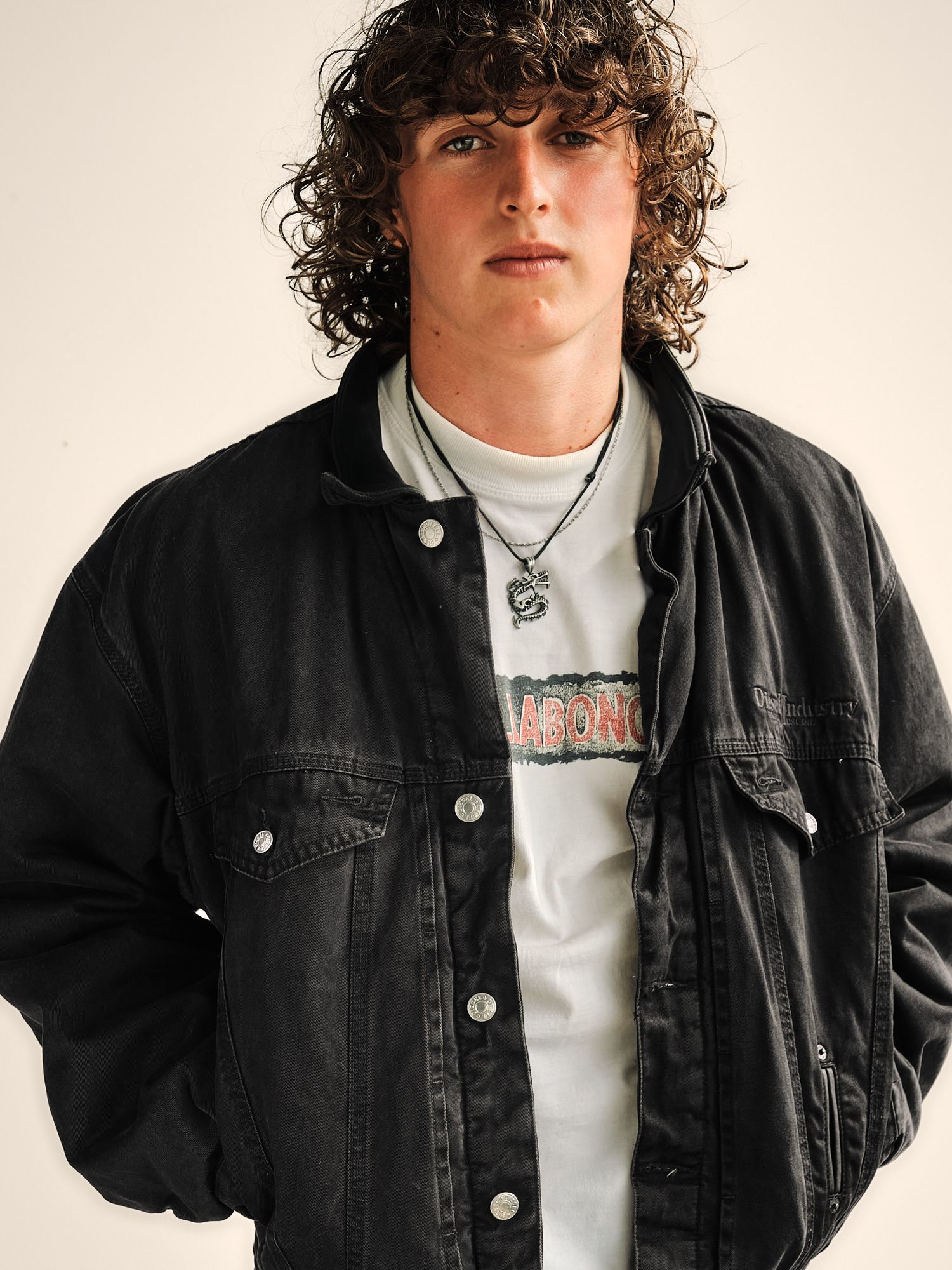 Portrait series showing a black denim jacket and white t-shirt against a light background.