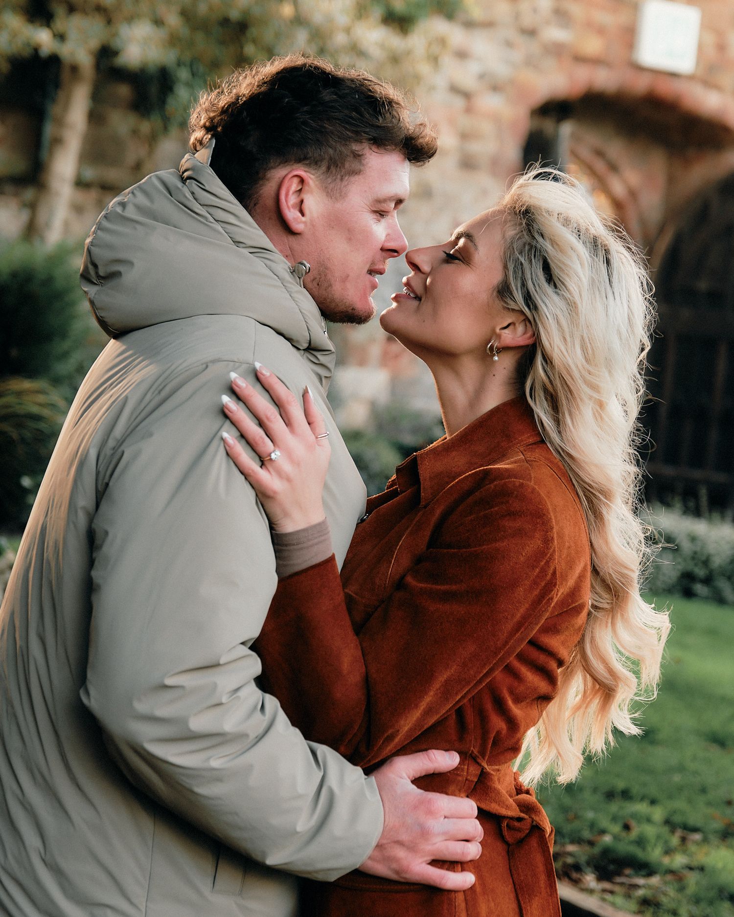 Series of intimate portraits showing a couple's tender moments in a garden setting.