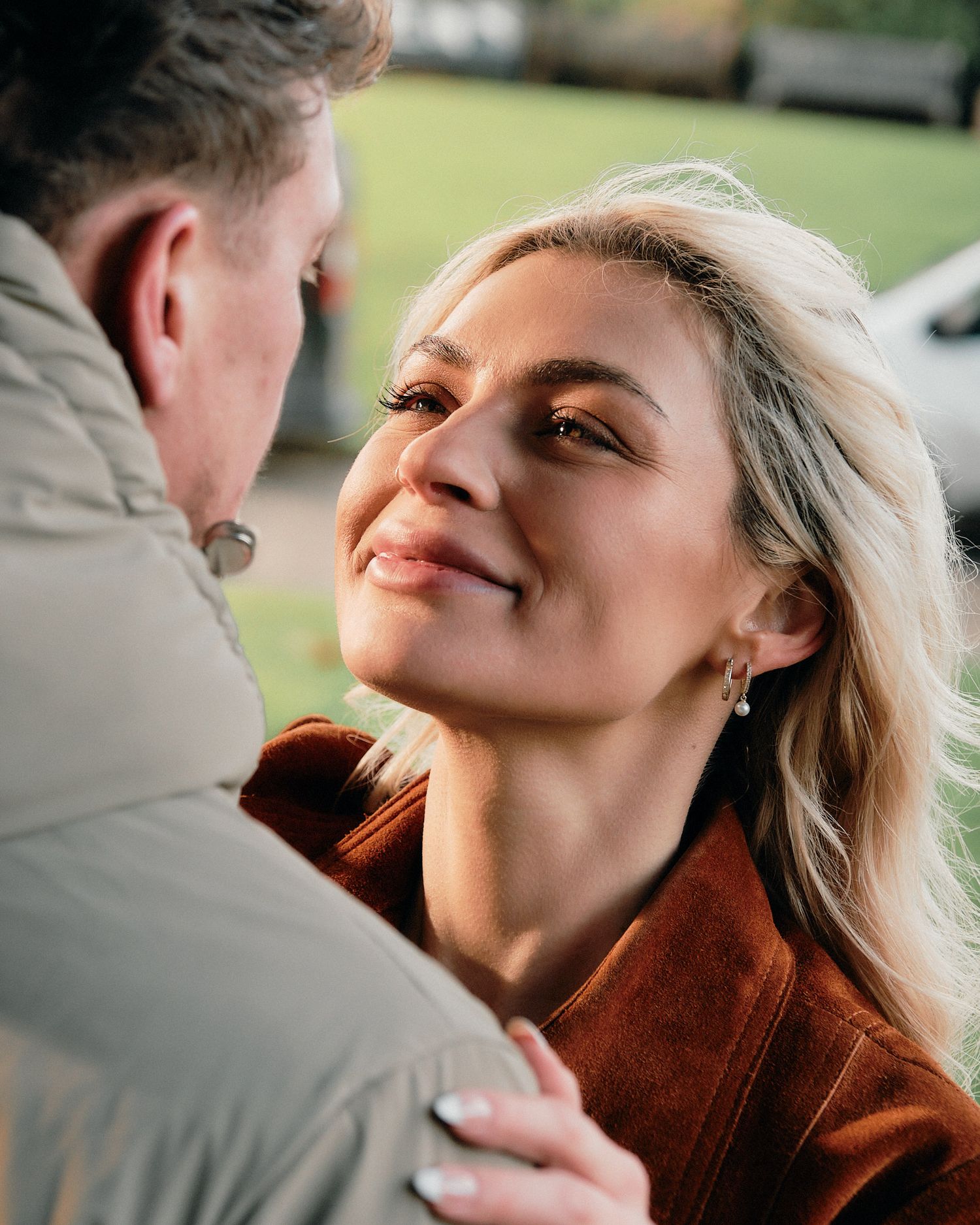 Intimate close-up shots of a couple sharing tender moments together outdoors.