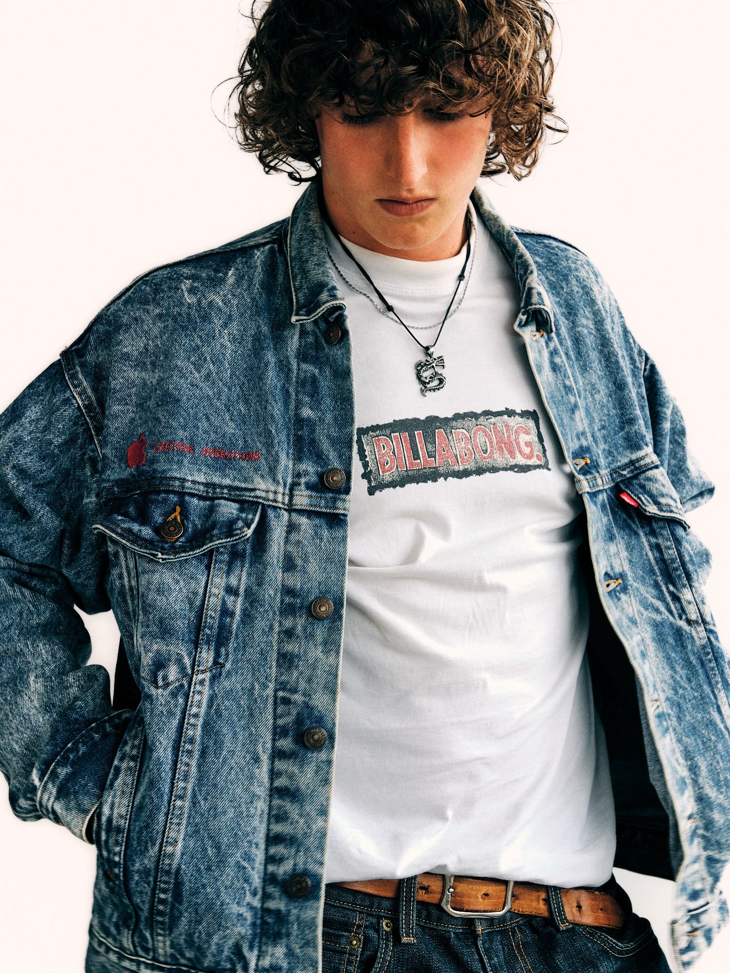 Close-up shots of a distressed denim jacket with white t-shirt and leather belt.