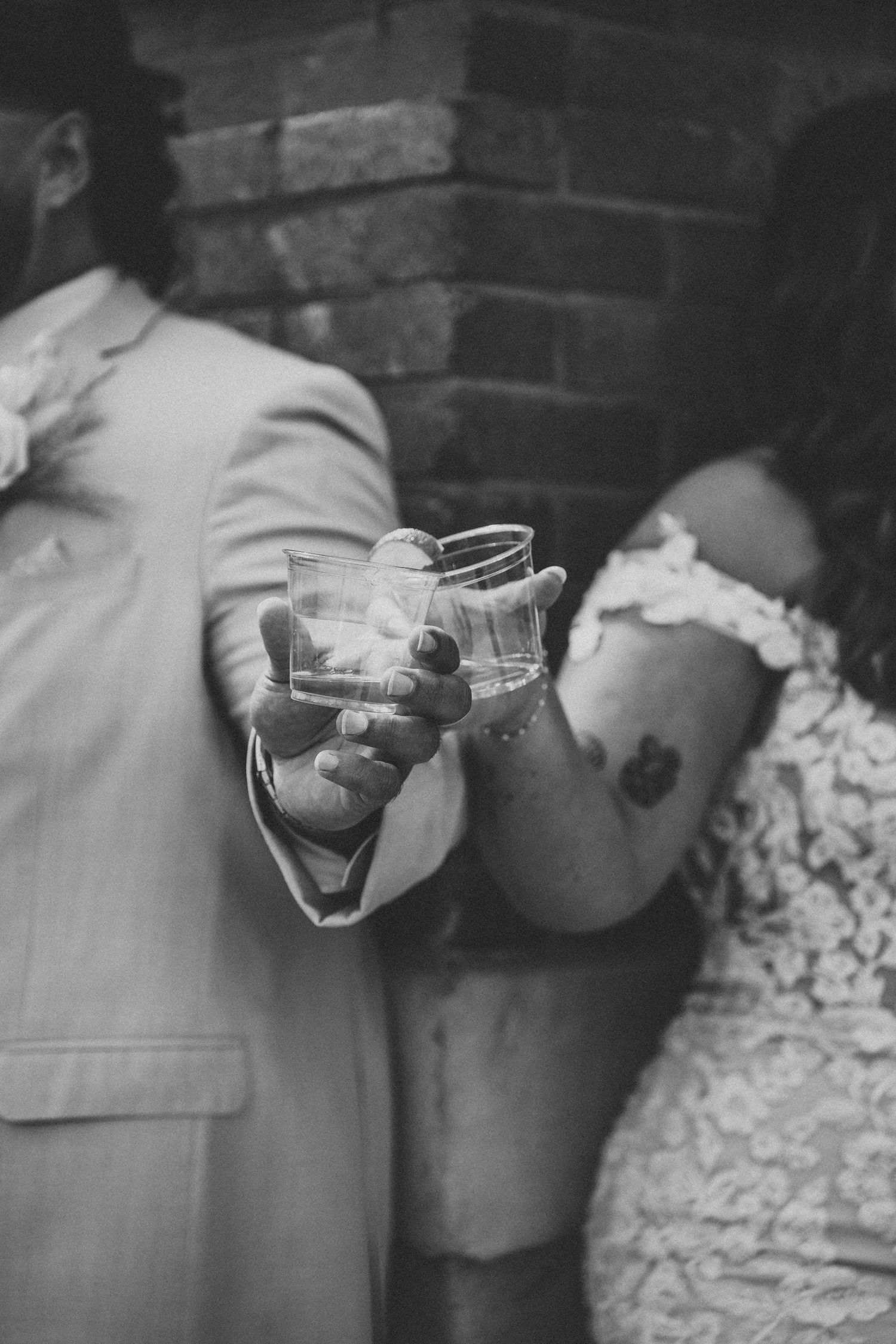 Close-up black and white photo of ccelebrating with a cheers.