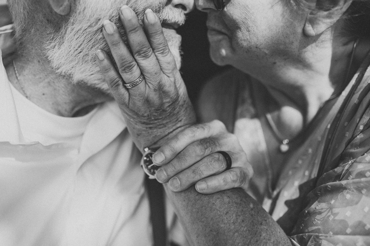 Intimate black and white close-up shots of tender moments between newlyweds.