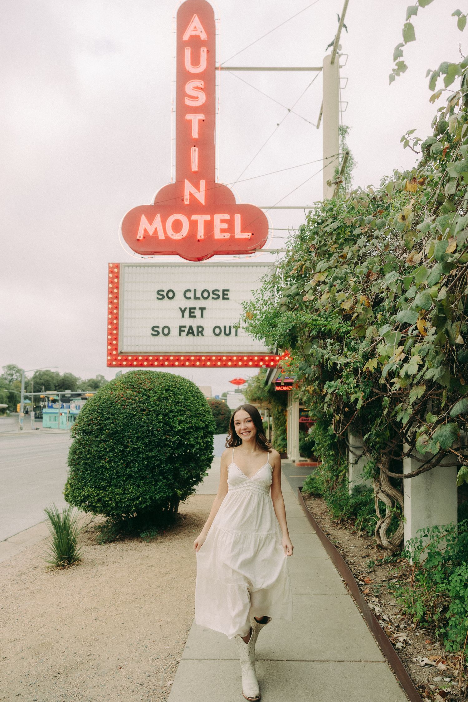 Retro motel sign and landscaping create nostalgic americana scene.