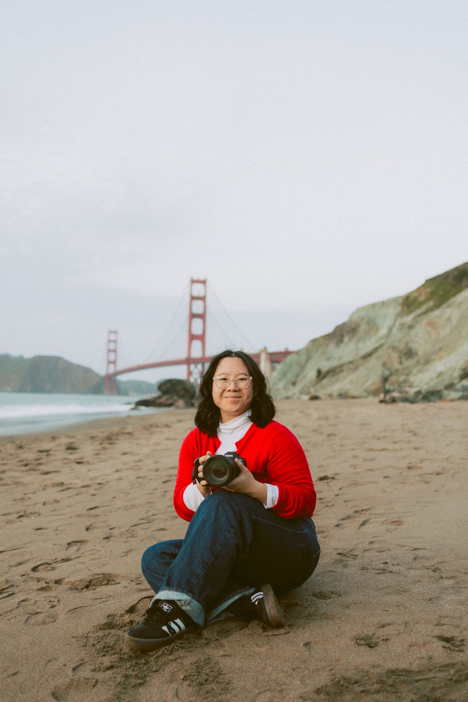 A series of photos showing someone in a red sweater relaxing on Baker Beach with the Golden Gate Bridge in view.