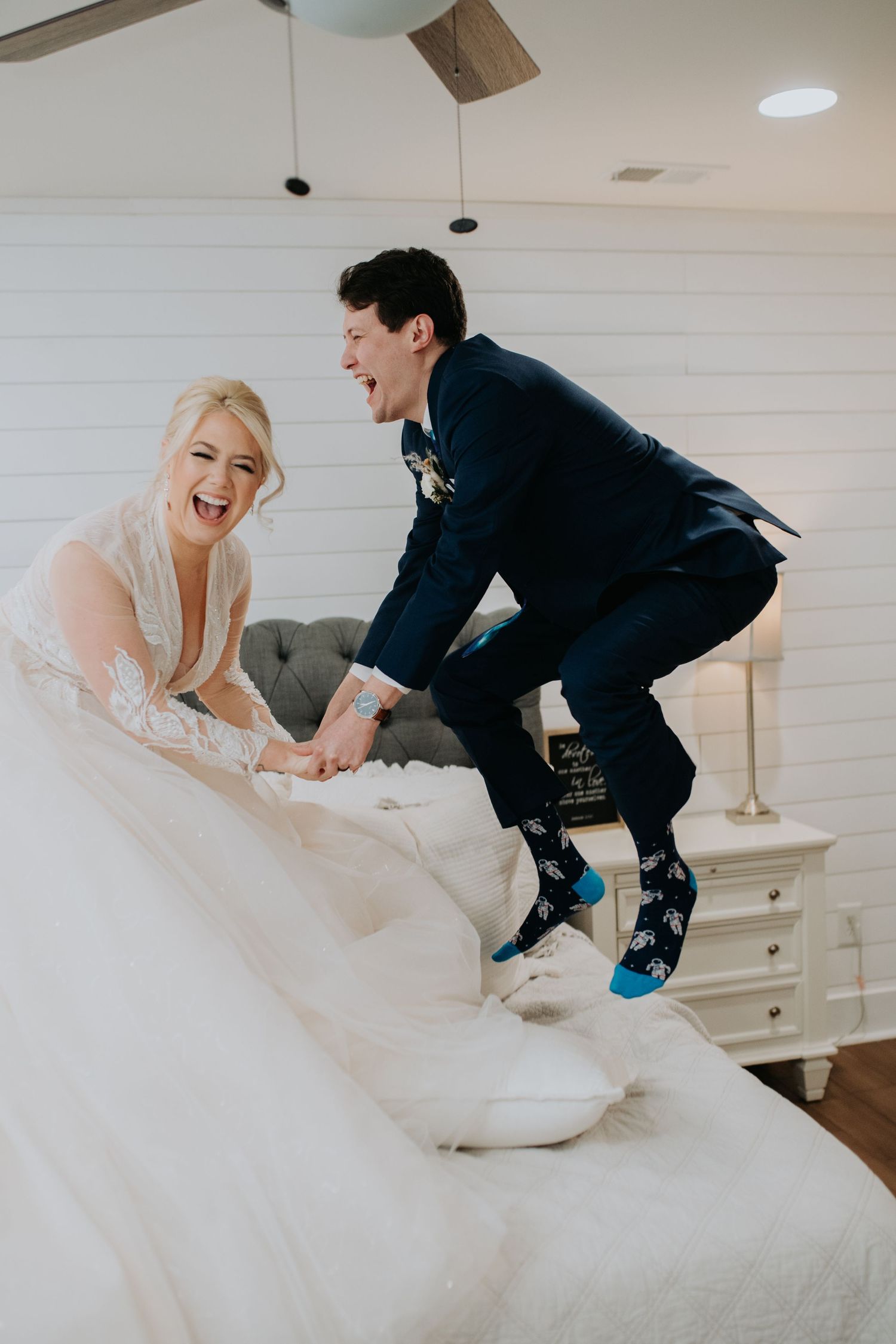 a couple jumps for joy on a bed at Hoyt hallow on their Alabama wedding day