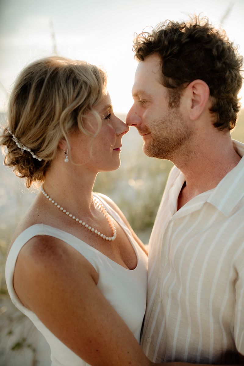 couple embracing at the Alabama gulf coast on their wedding day by Holli Hobbs photography