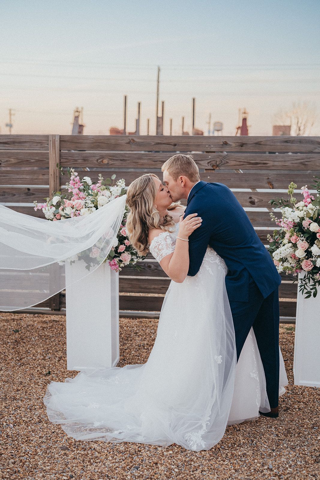 a couple kisses at Avenue D event center in Birmingham Alabama over looking Sloss furnace for their wedding day