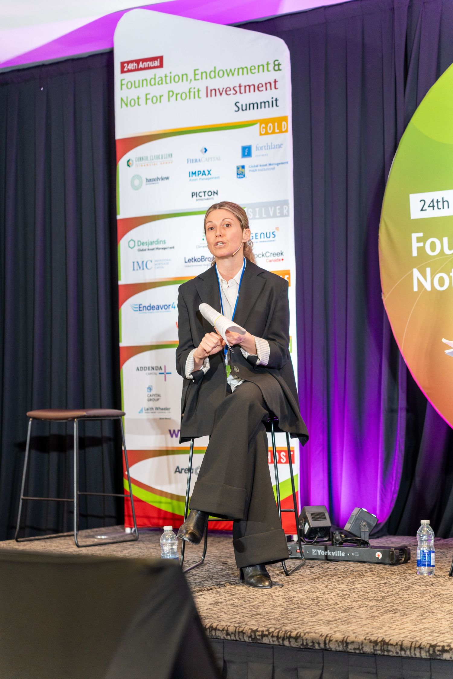 Female speaker presenting on stage at the 24th Annual Foundation Endowment and Not For Profit Investment Summit.