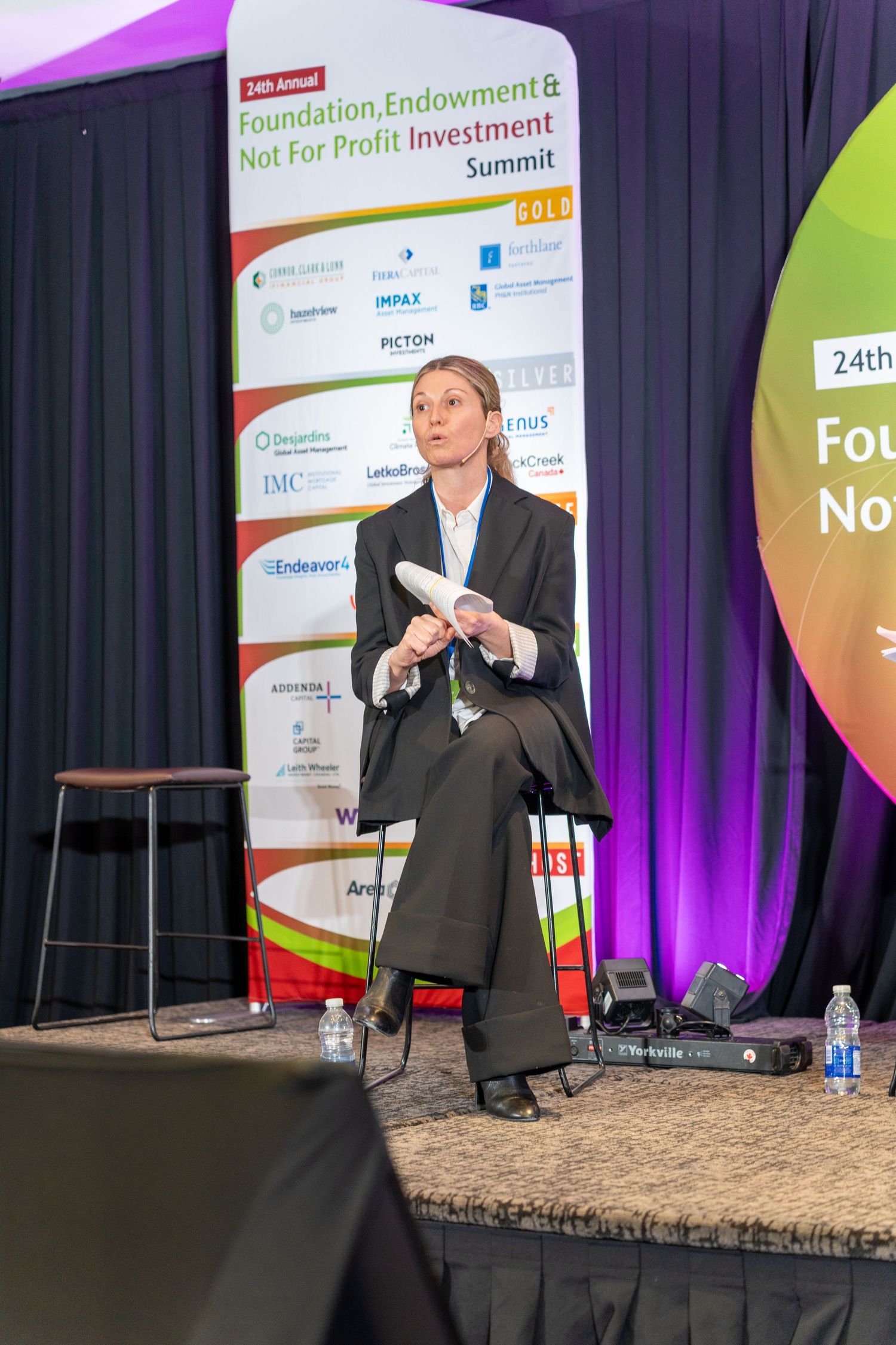 Woman speaker sits on stage at the 24th Annual Foundation Endowment and Not For Profit Investment Summit.