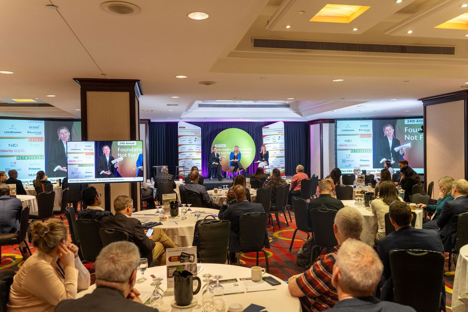 Attendees seated at round tables during the Foundation Endowment Not For Profit Investment Summit conference.