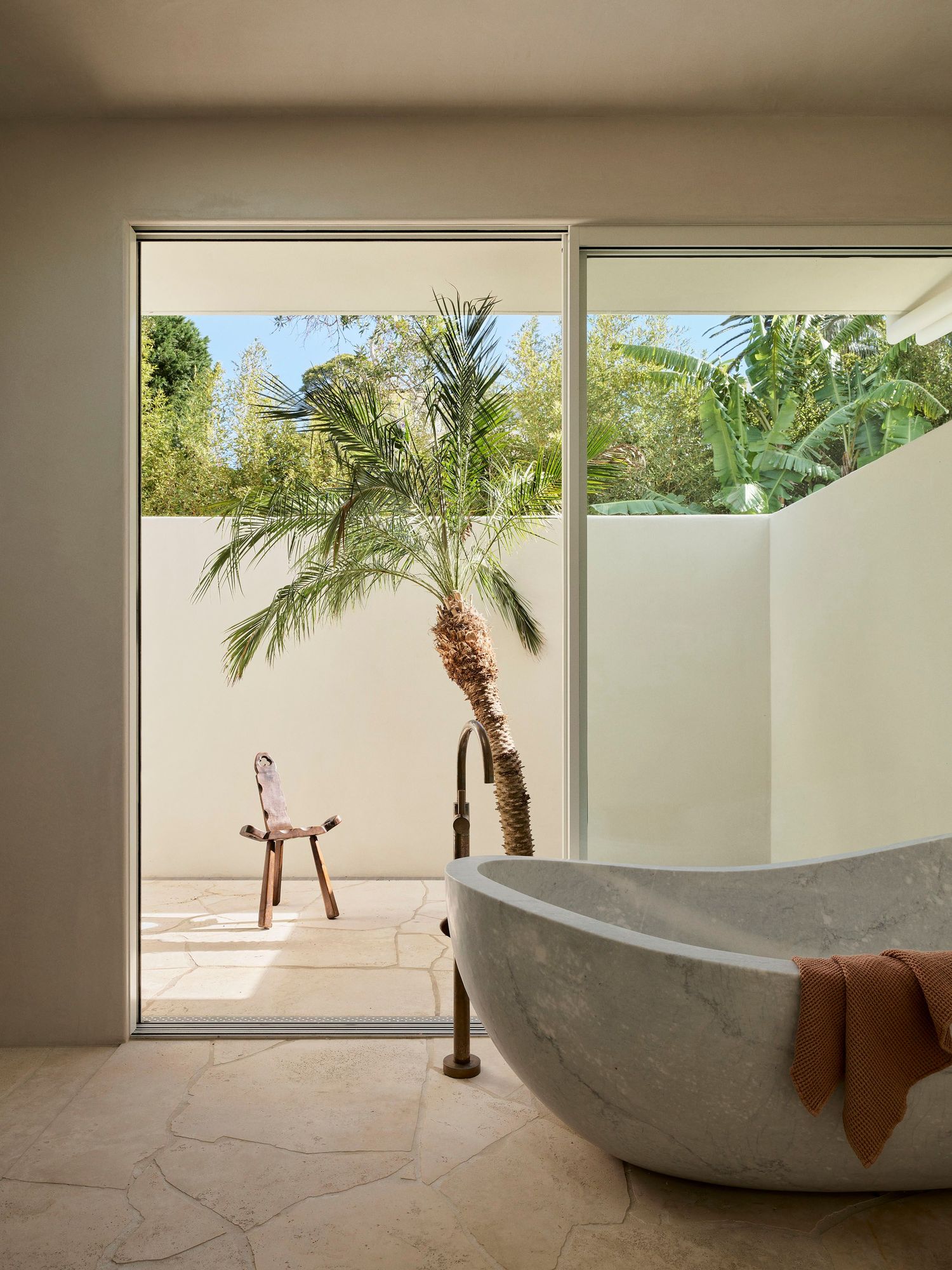 Alaia Palm Beach, solid stone bath and courtyard.