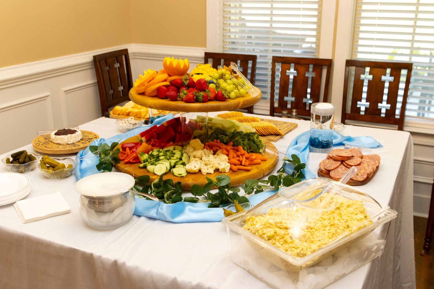 An elegant table setting with seafood platters, fruit displays and other dishes for a special occasion.