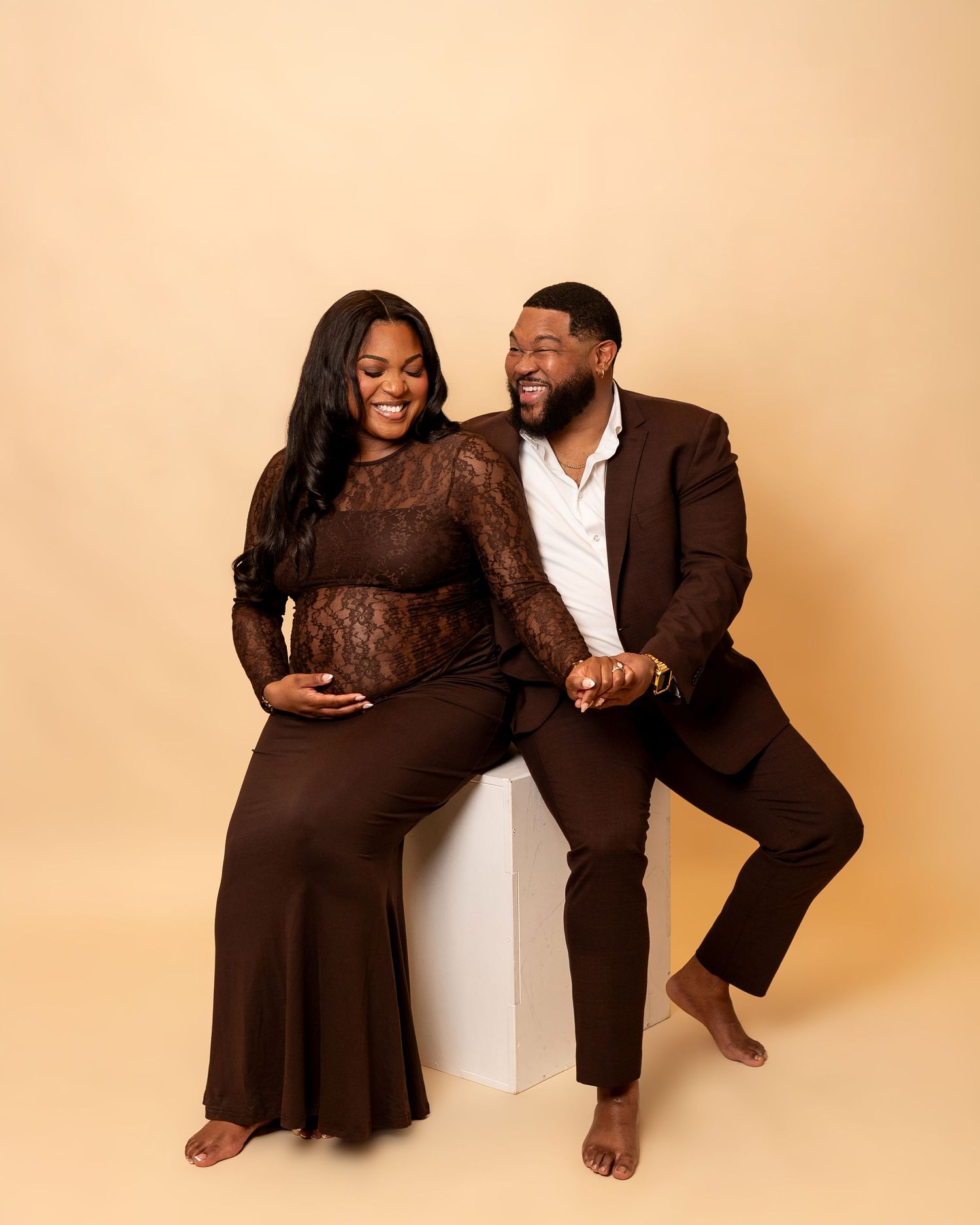 A couple in brown and white outfits poses playfully together in a series of candid studio photos against a beige backdrop.