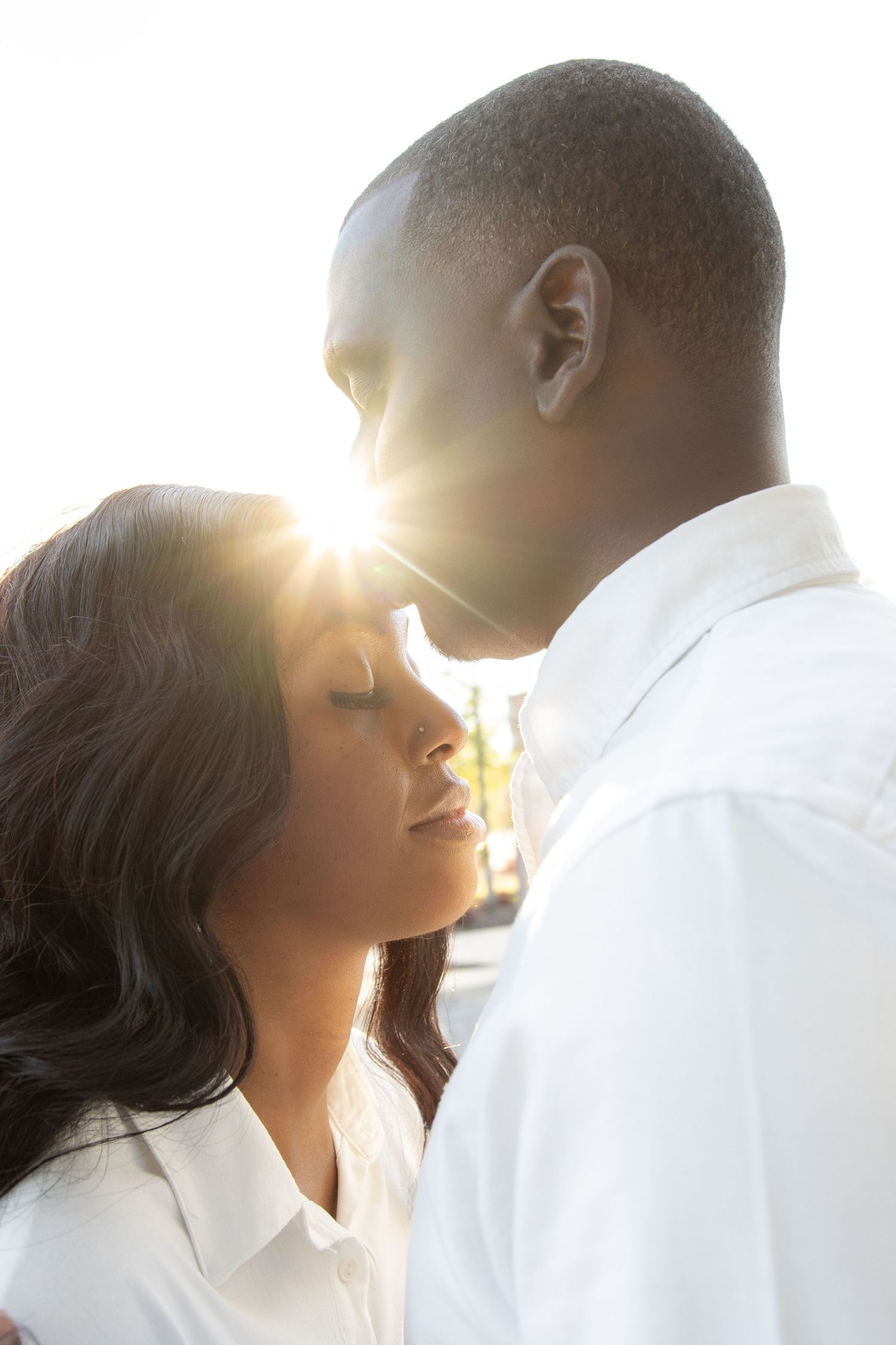 Romantic couple silhouettes embrace against sunlit sky in four soft dreamy poses.