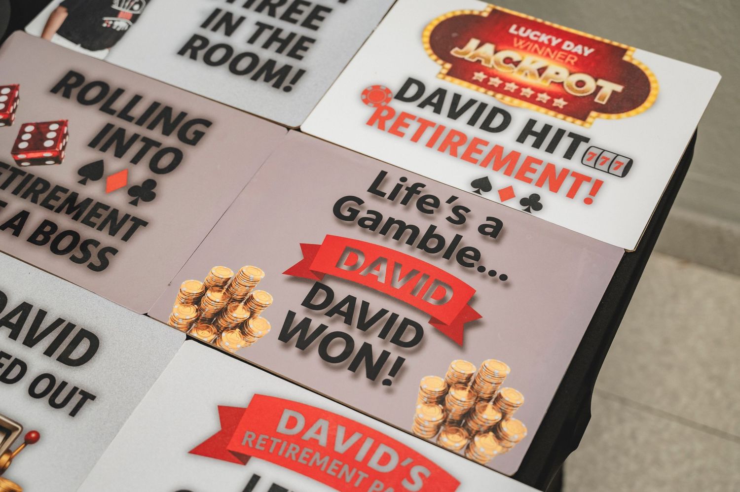 A close-up shot of sticker name tags and awards from a casino-themed party or event.