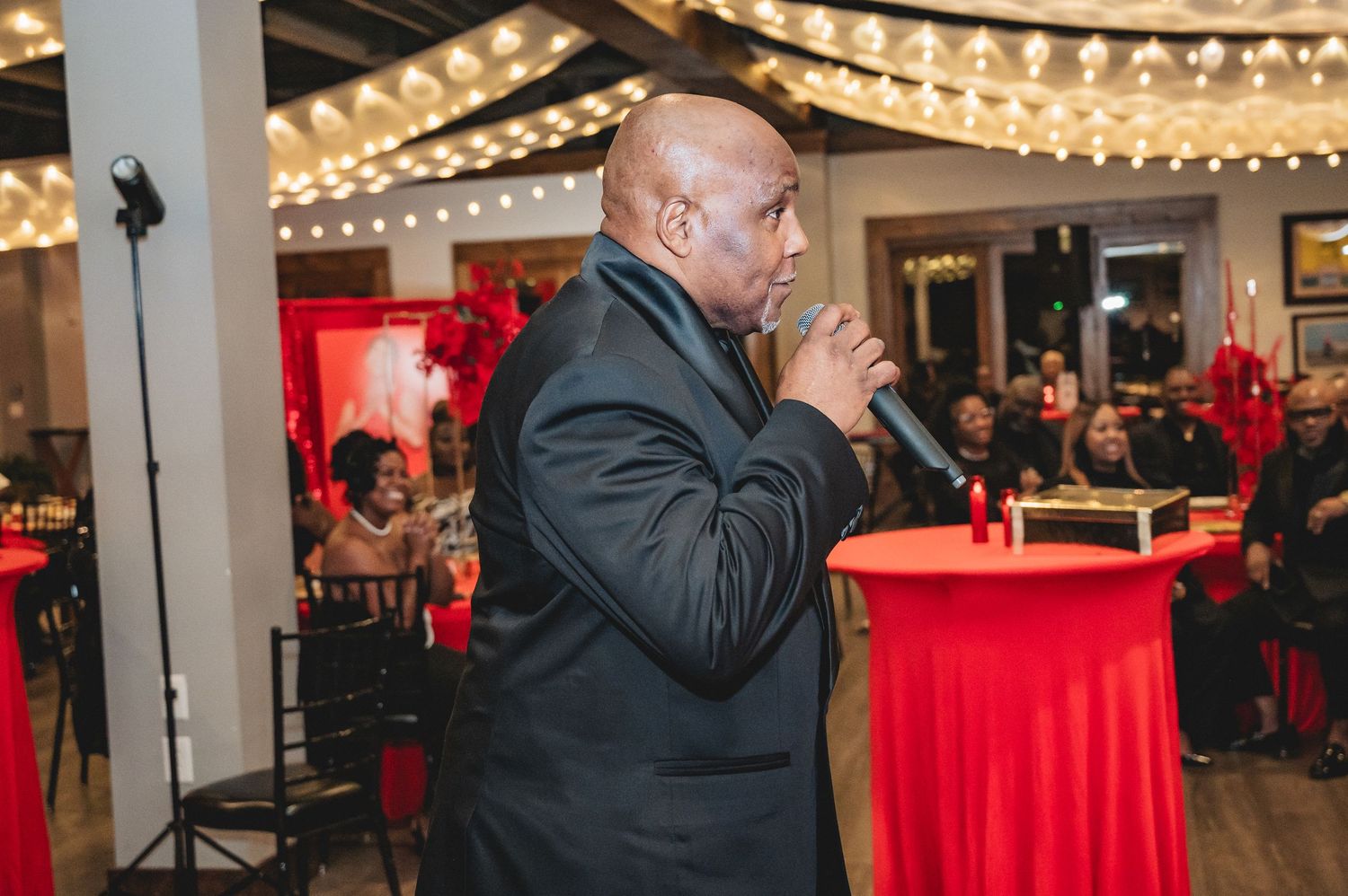 Event space with string lights and exposed brick walls creating warm ambiance for celebration.