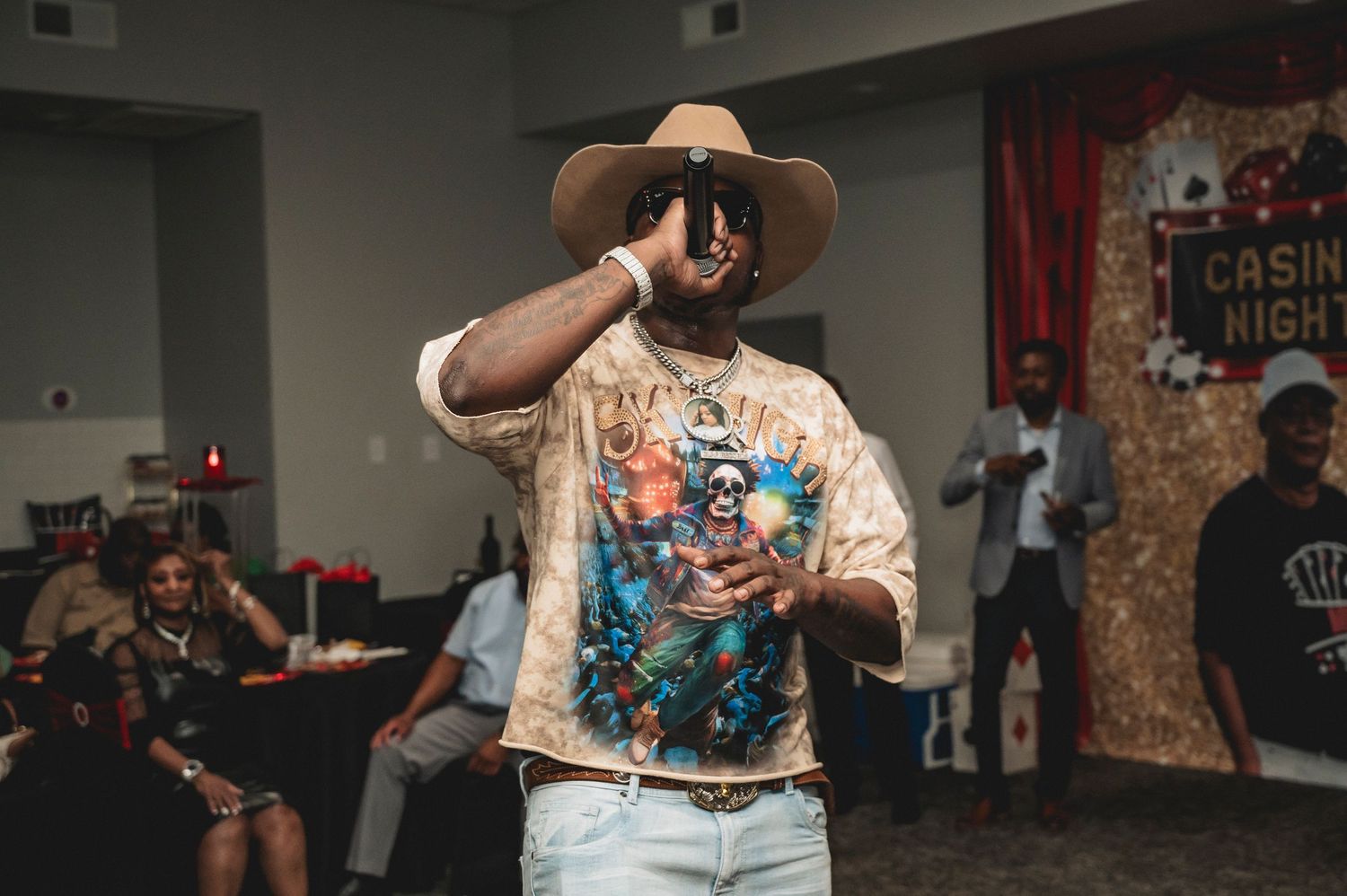 People performing and dancing at indoor event with western themed attire.