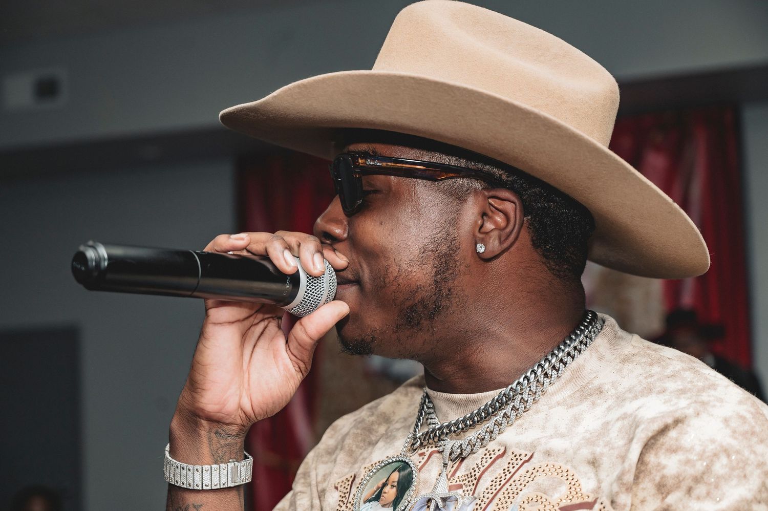 Entertainment performers on stage wearing beige cowboy hats at a casino themed event.