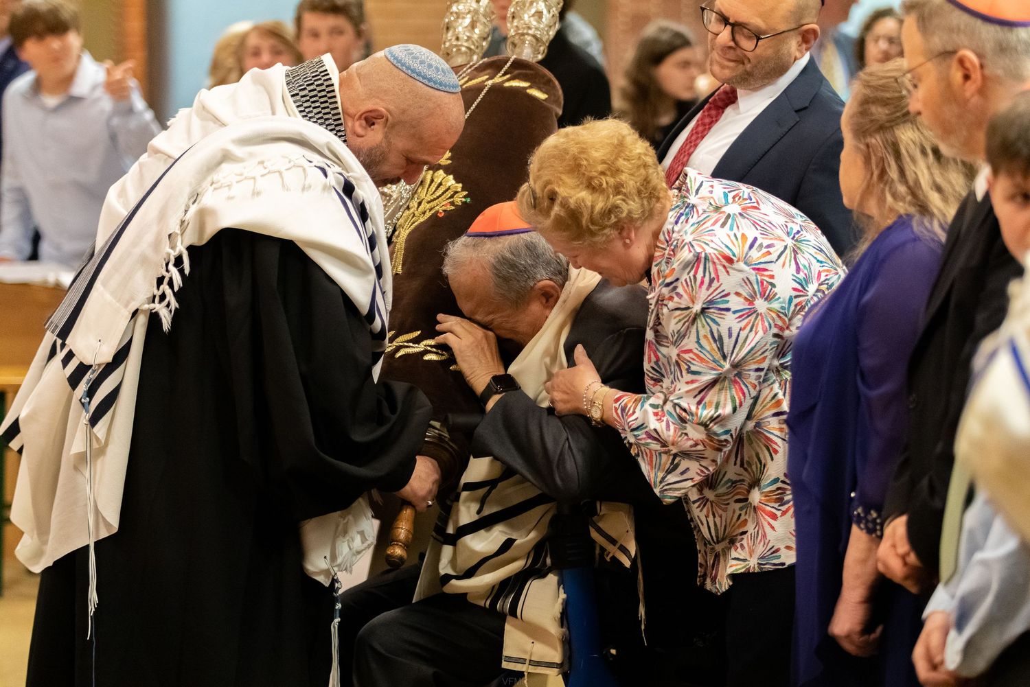 Jewish congregants read from prayer books during a religious service at a synagogue.