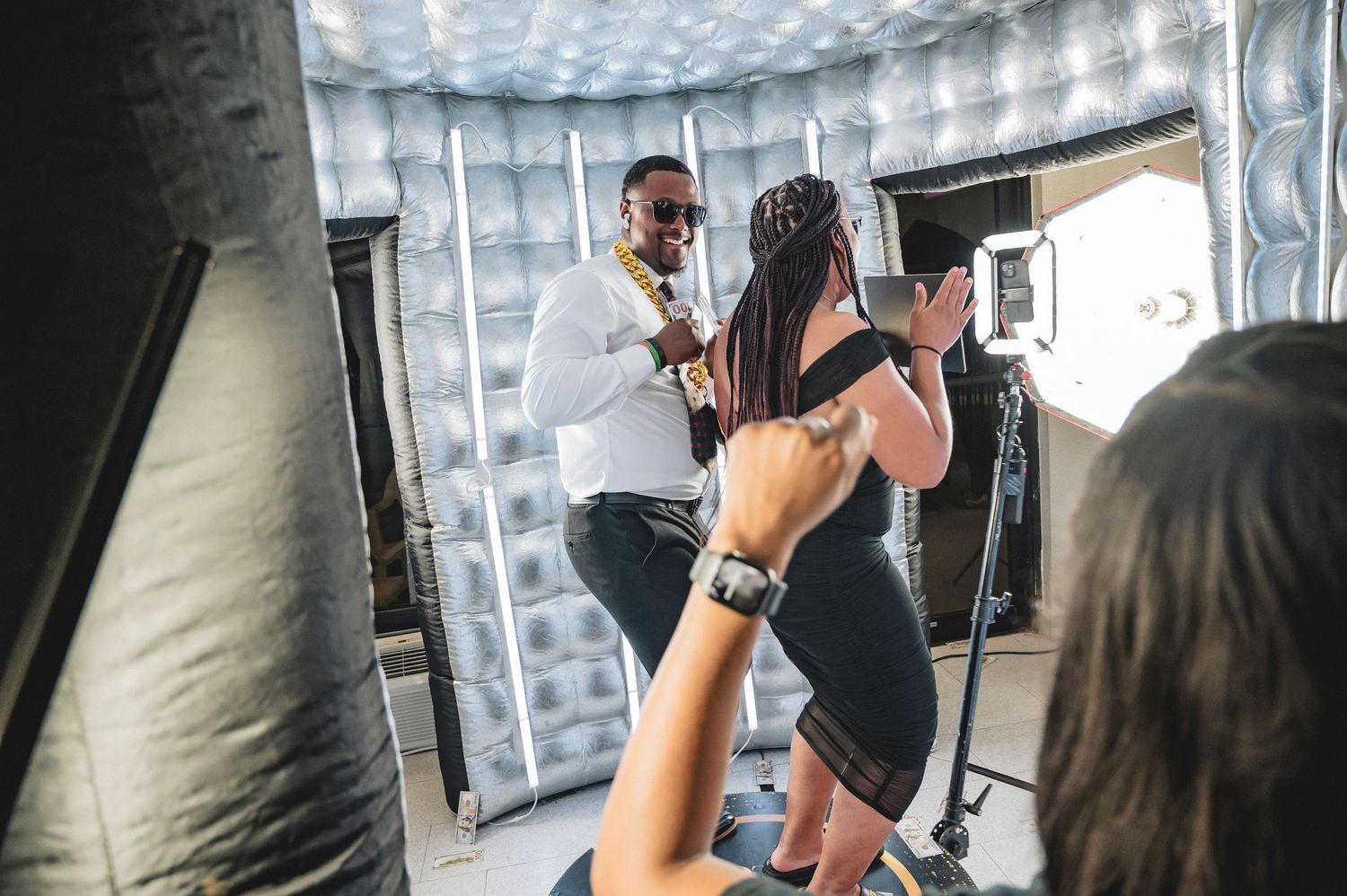Professional photo shoot setup with lighting equipment and reflectors.