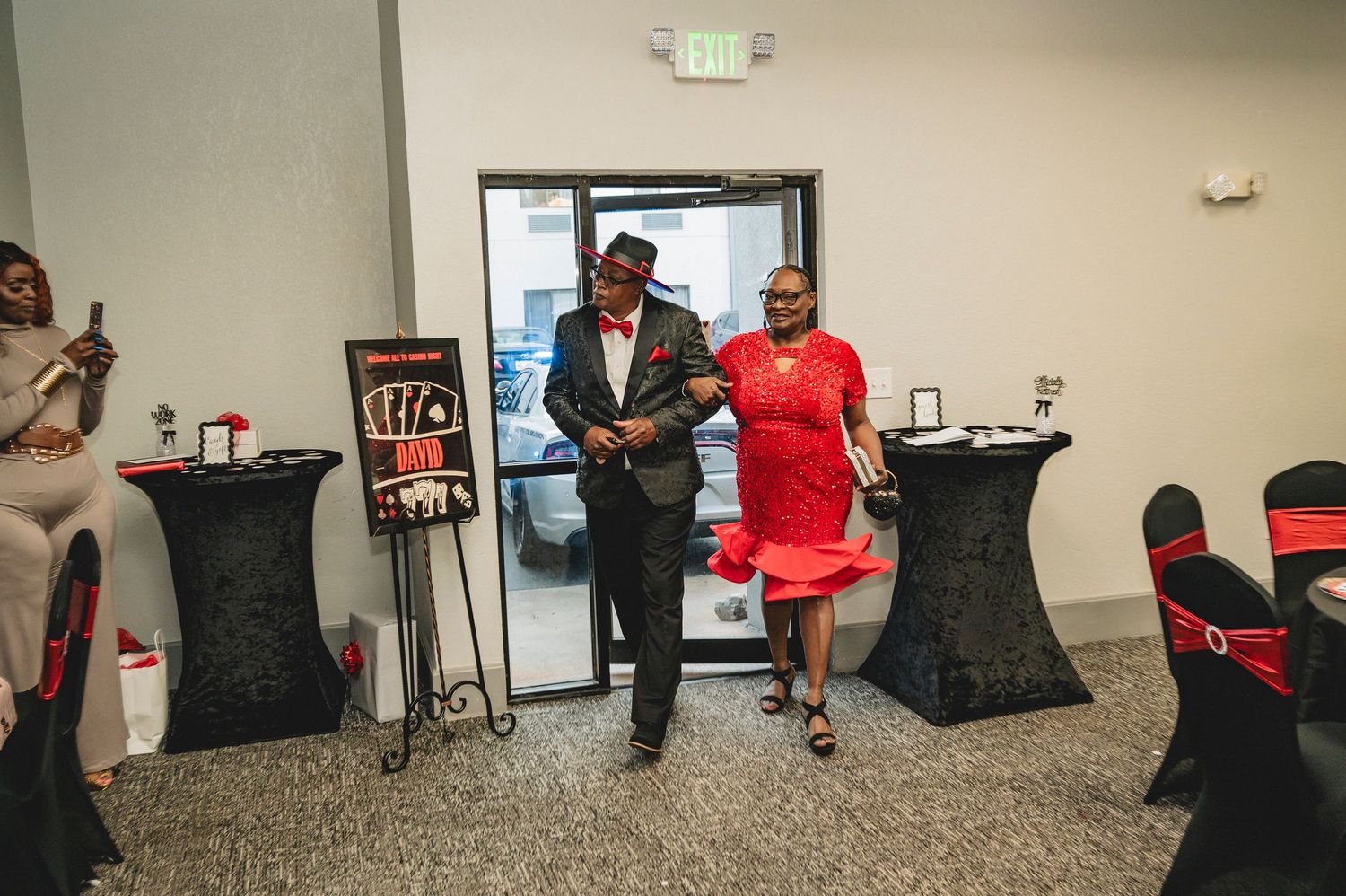 Attendees walking through a venue decorated for a casino-themed celebration.