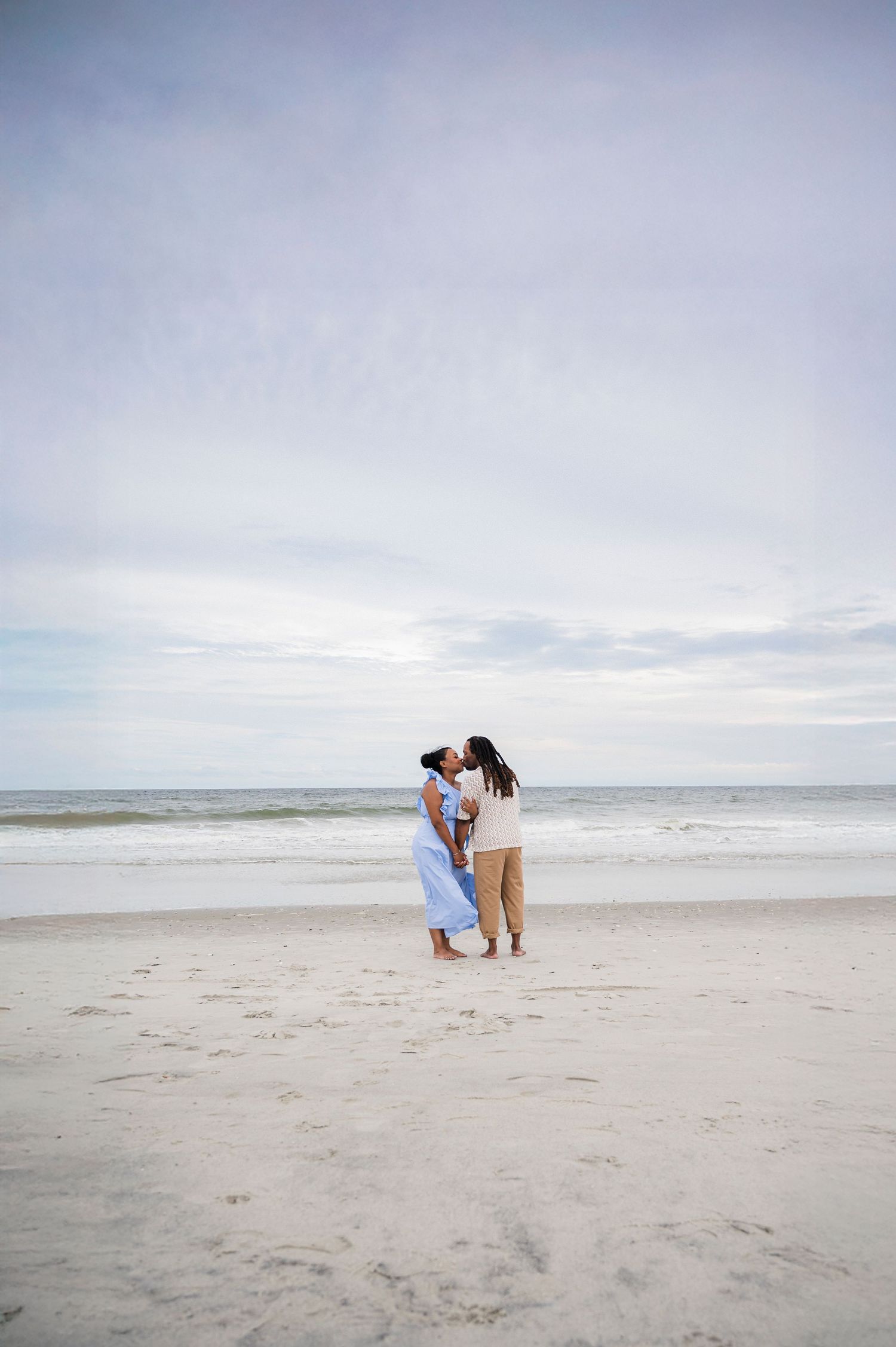Multiple photos of people at a minimalist, serene beach scene with soft cloudy skies and white sandy shoreline.