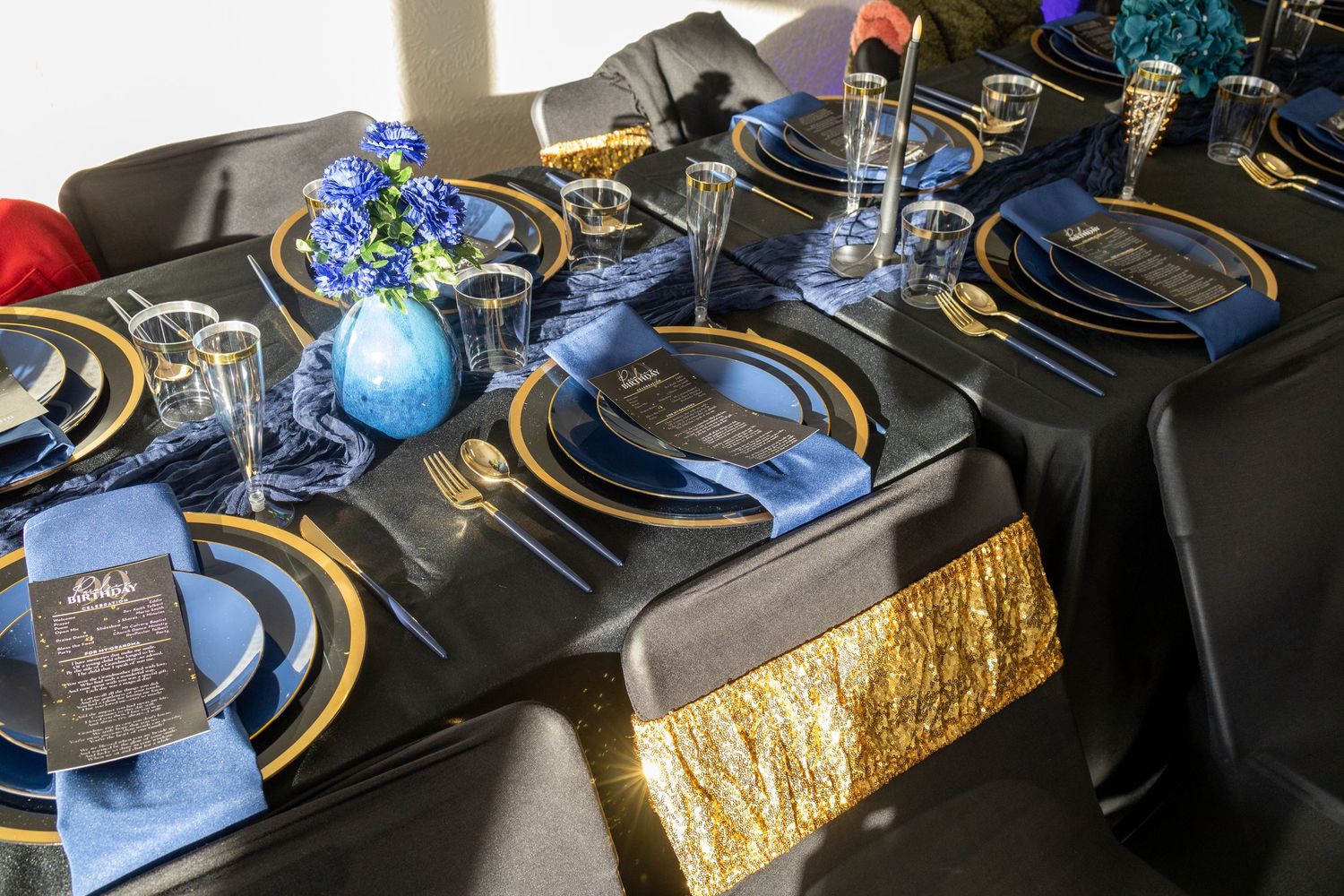 Blue and gold table settings with metallic details create an elegant holiday dining atmosphere.
