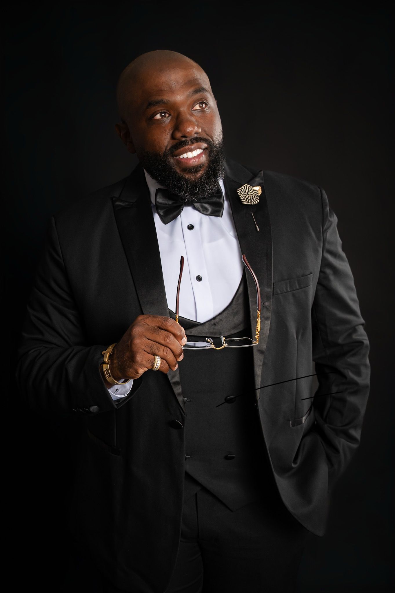 Professional portrait series showing a person in a classic black tuxedo and white shirt against dark background.