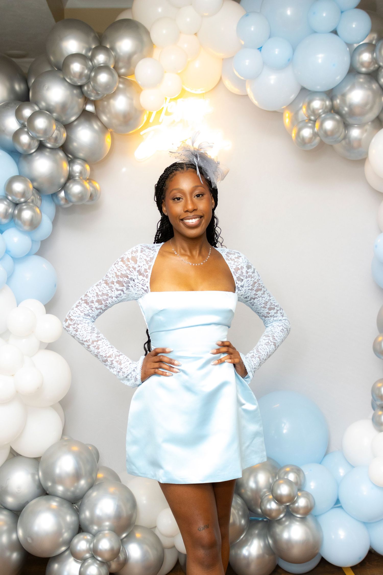 Elegant balloon arch display featuring silver, white and baby blue colors for a special celebration.