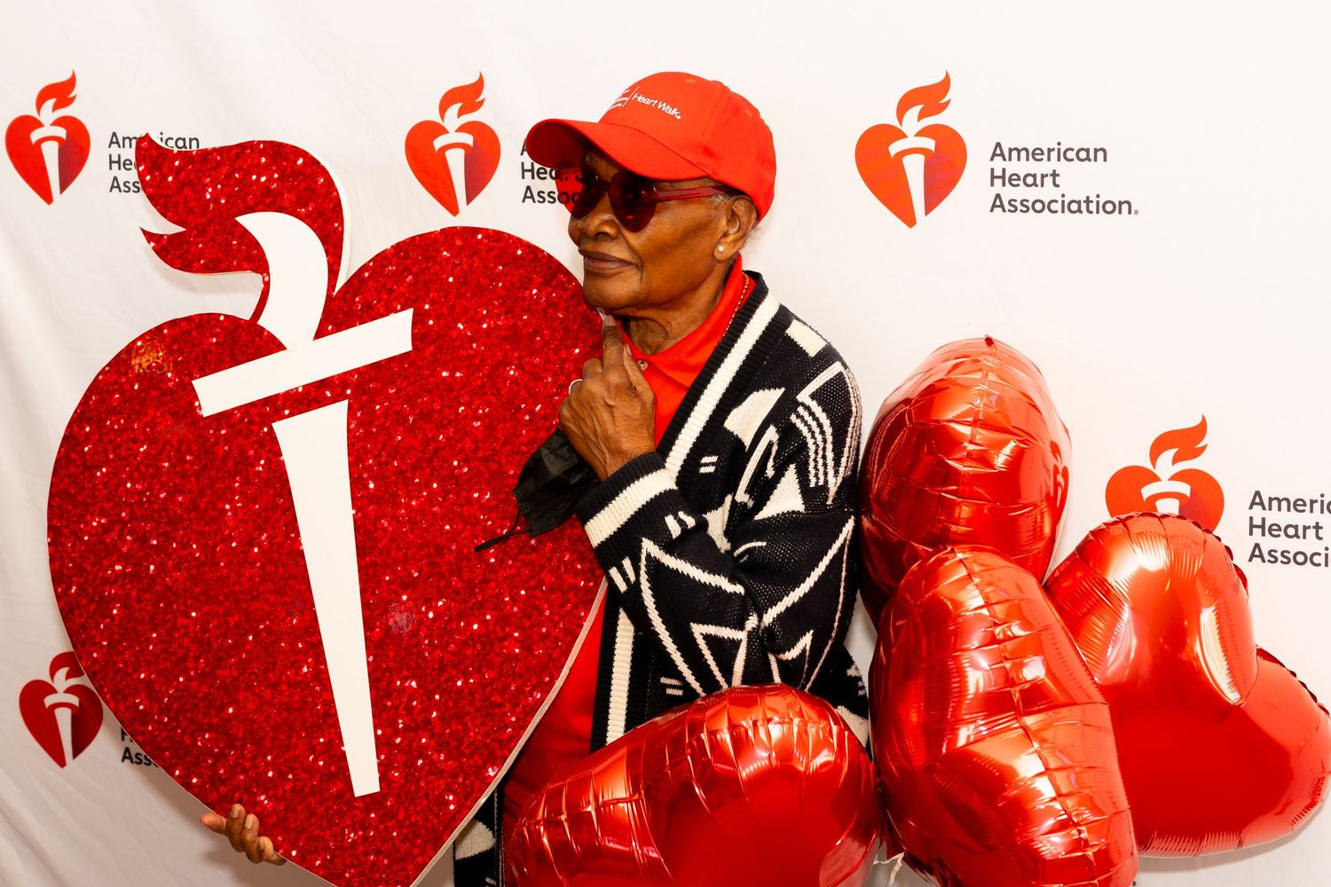 Red and white American Heart Association promotional banner showing heart symbols and health-related imagery.