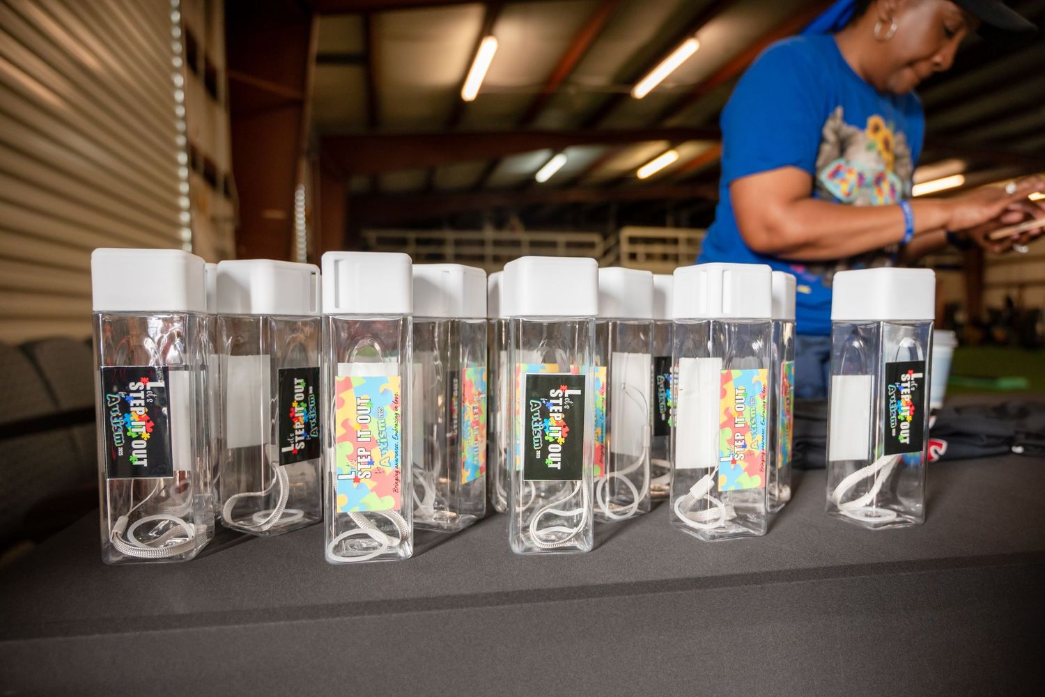 Row of custom printed drinking glasses displayed on a shelf showcasing artistic designs and patterns.