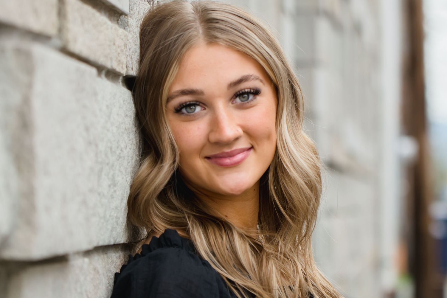 Portrait series with soft lighting against textured wall background. Senior photoshoot in Enumclaw, WA