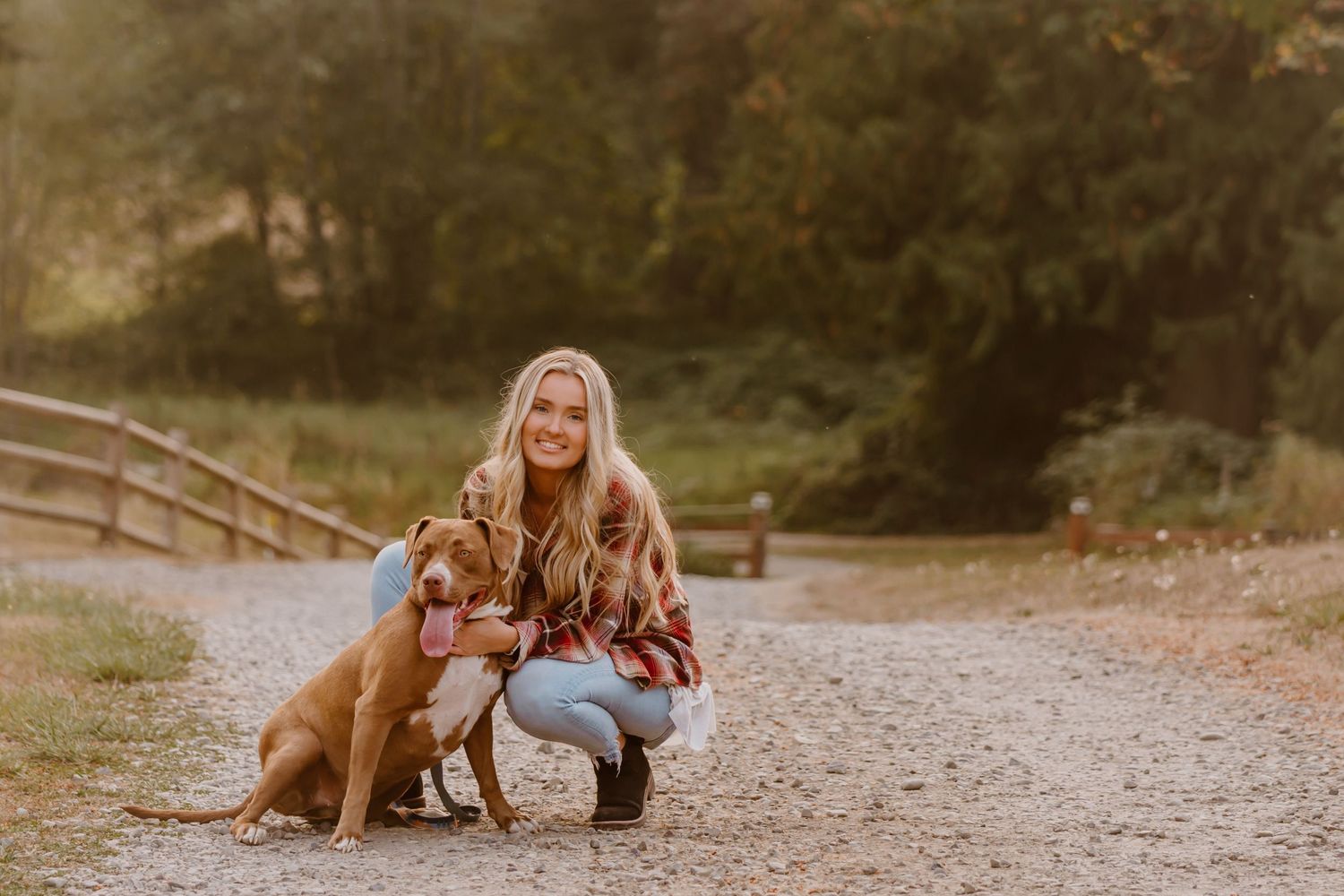 Dog sitting on dirt path with a girl during autumn photo session in Enumclaw, WA
