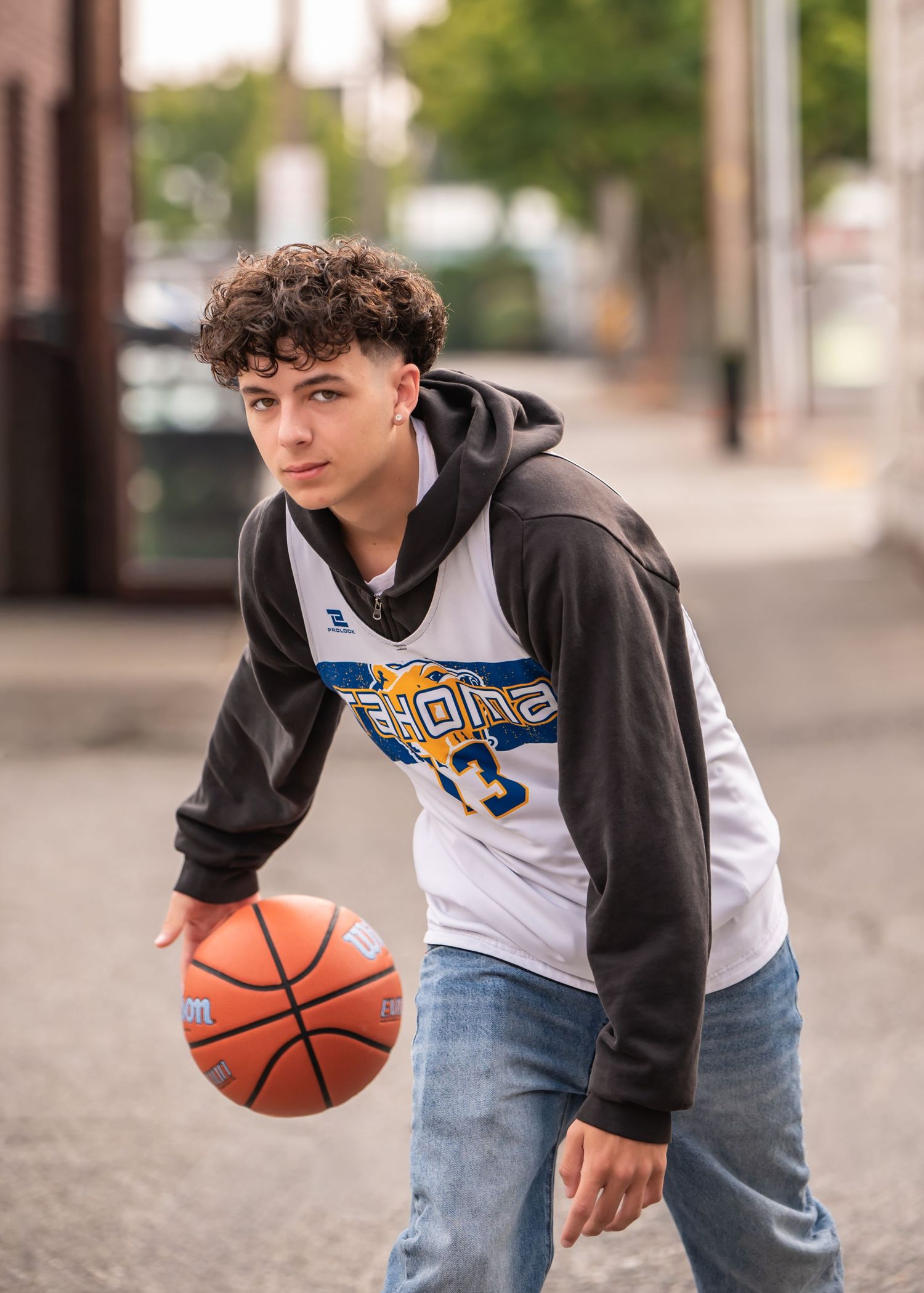 Tahoms HS basketball player dribbling on urban concrete in casual athletic wear in Enumclaw, WA. Senior photos