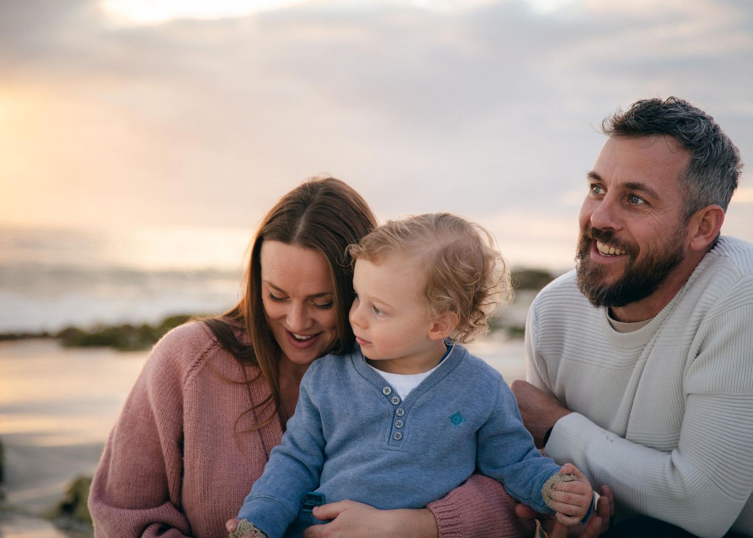 A toddler and his family at Quins Beach, WA at sunset