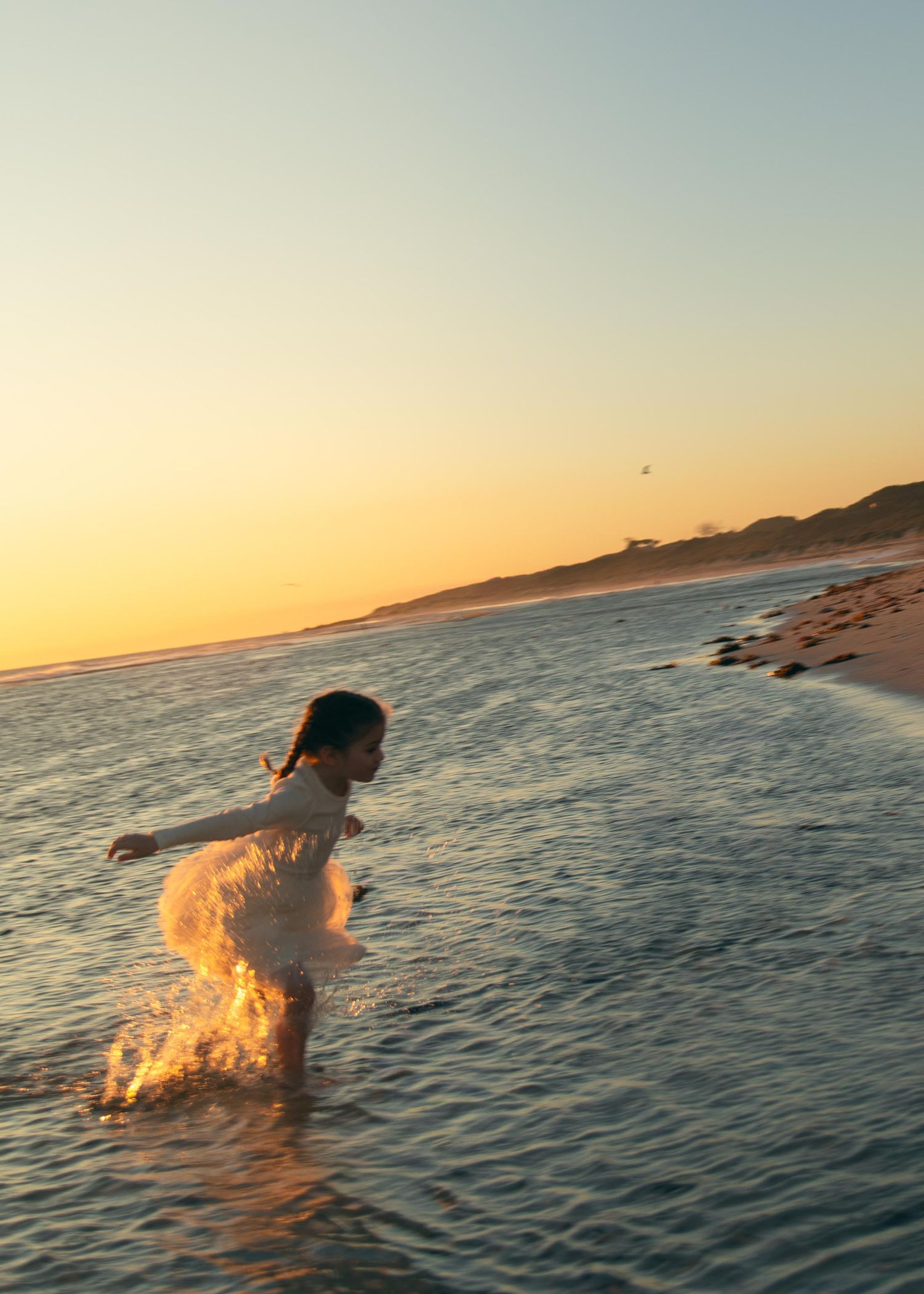 A young girl running at sunset at Yanchep Lagoon