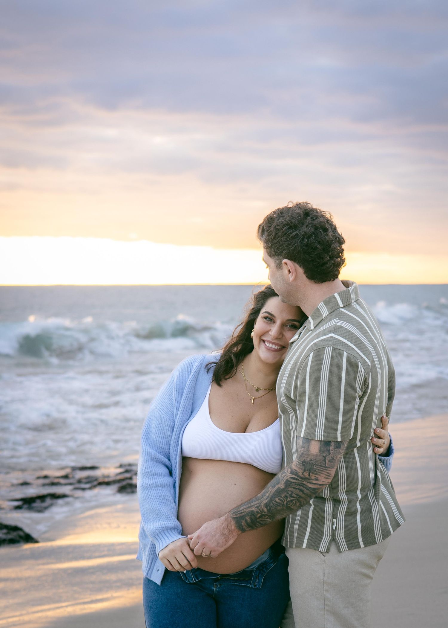 A pregnant woman and her husband at Burns Beach WA