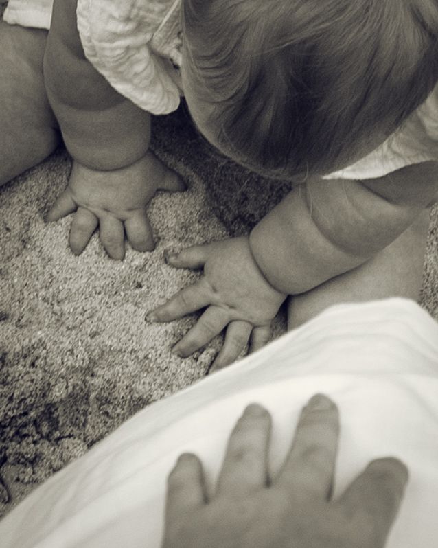 Photo of baby hand and her mums hands. B&W. Burns Beach, Perth, WA.