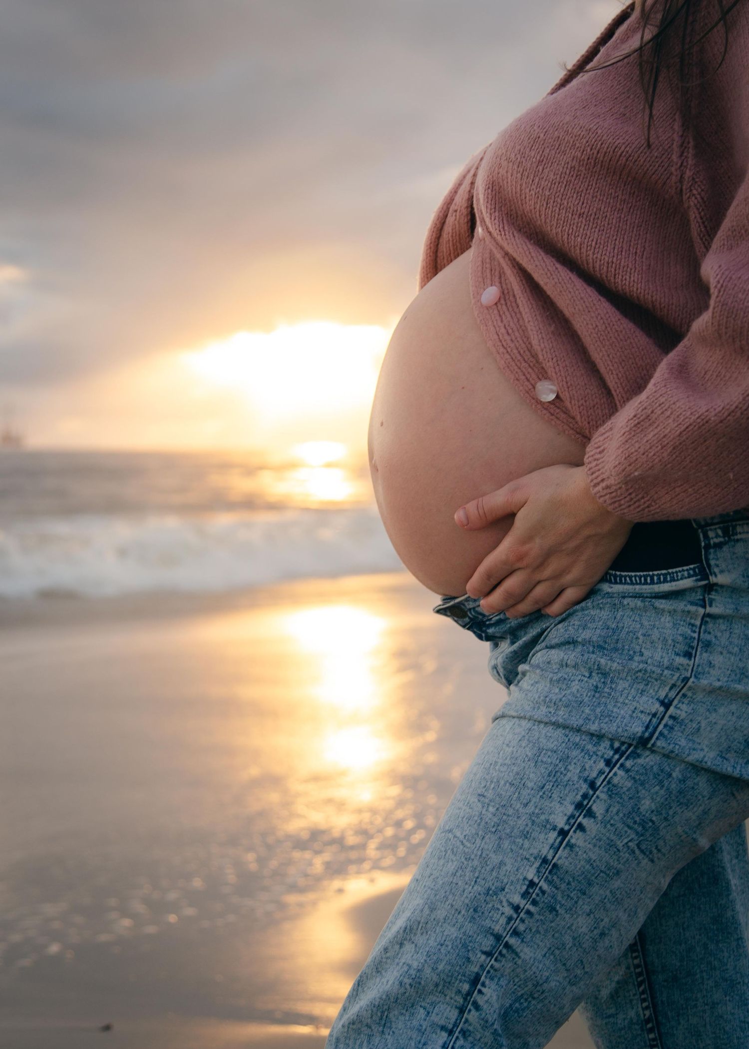 A pregnant woman in the sunset at Quinns Beach