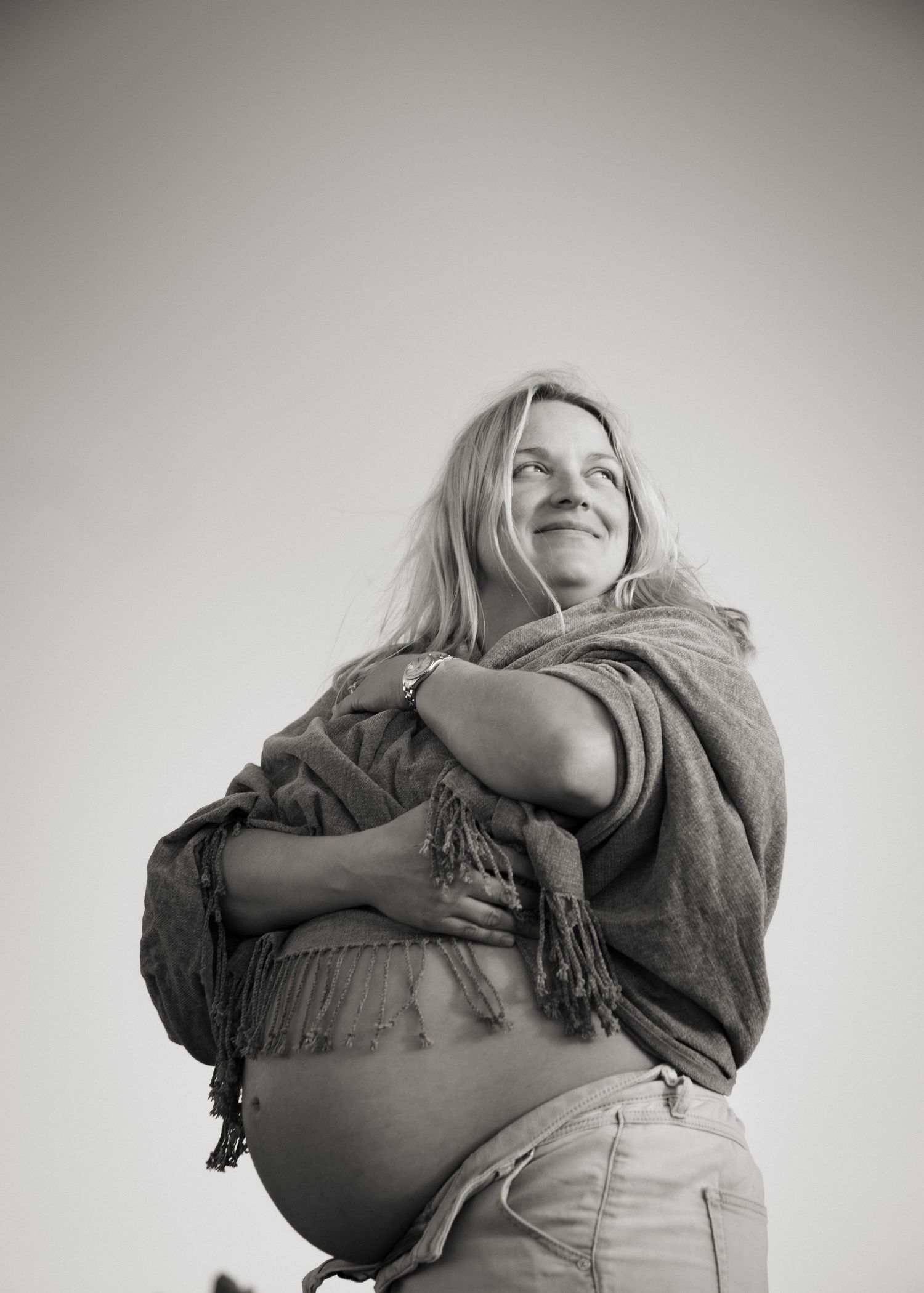 Pregnant woman covering up with a blanket
