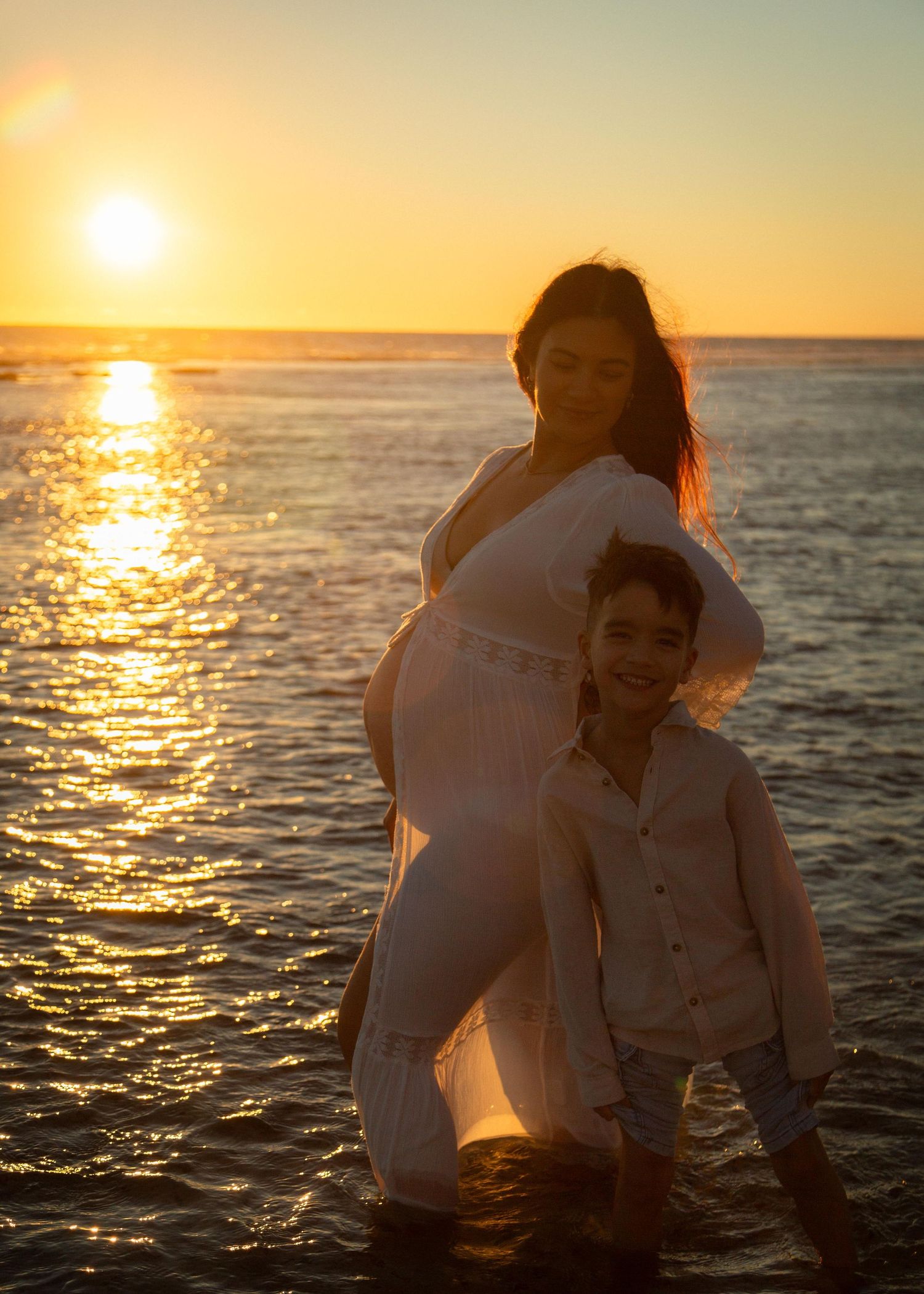 A pregnant woman and her son at sunset at Yanchep Lagoon