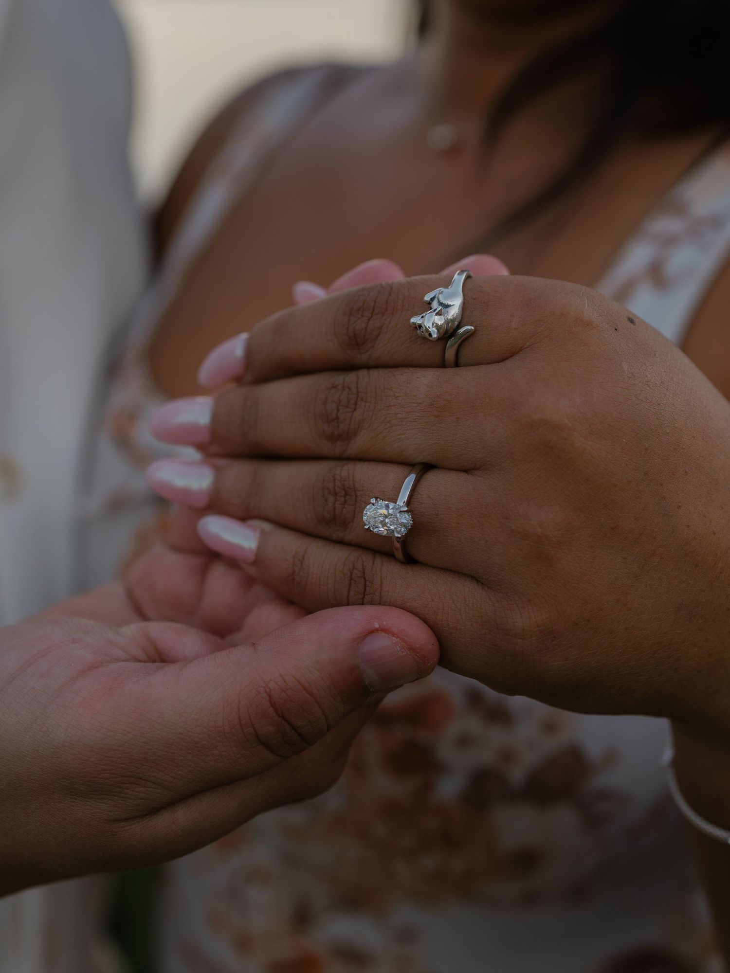 A close-up sequence showing hands exchanging an engagement ring during a romantic proposal moment.