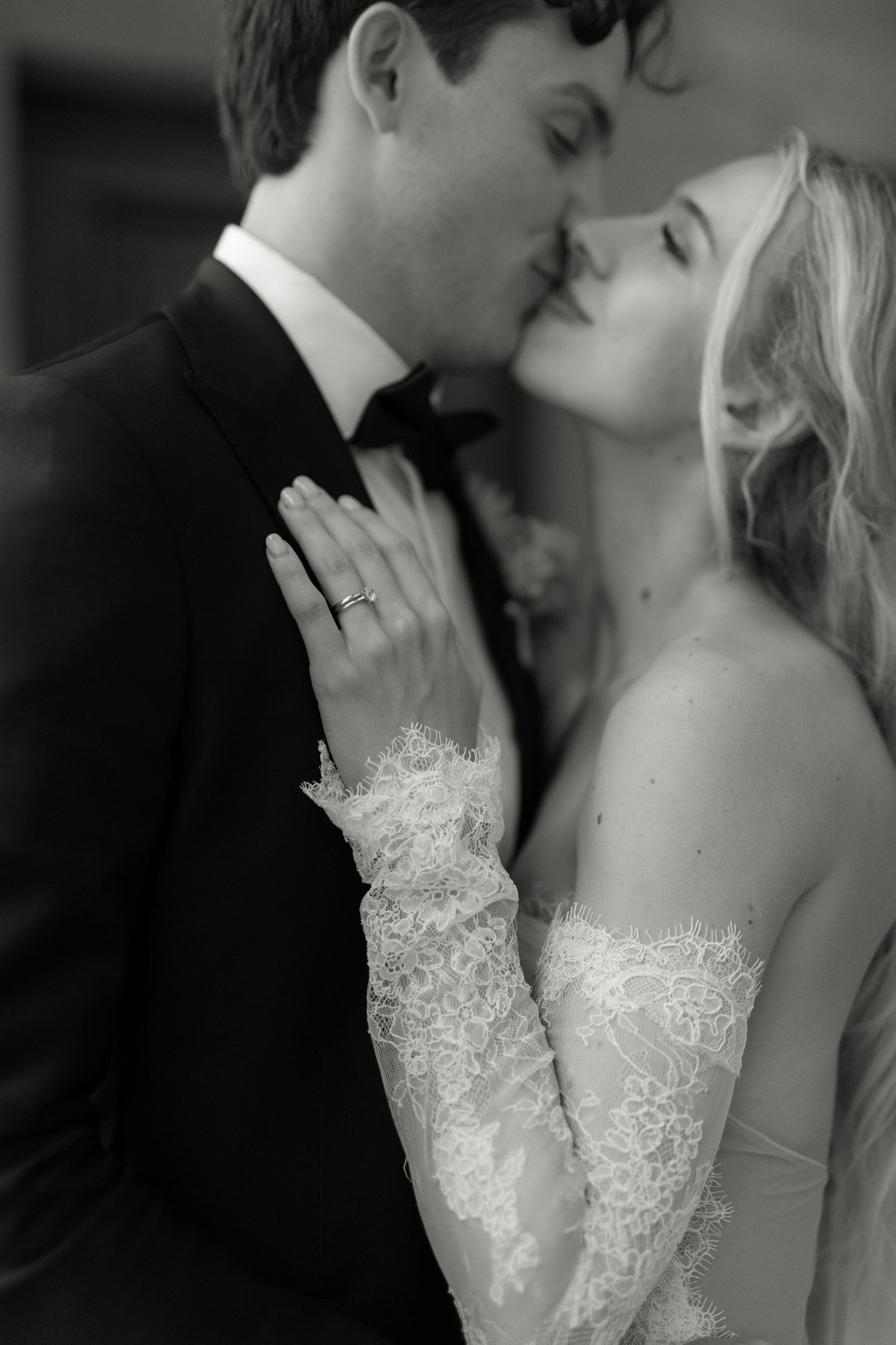 Intimate black and white portrait of a wedding couple sharing a romantic moment.