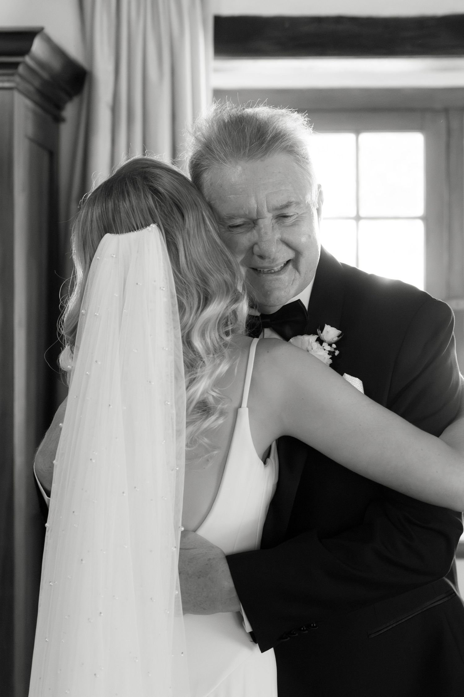 Touching black and white moment captured during emotional wedding day celebration.