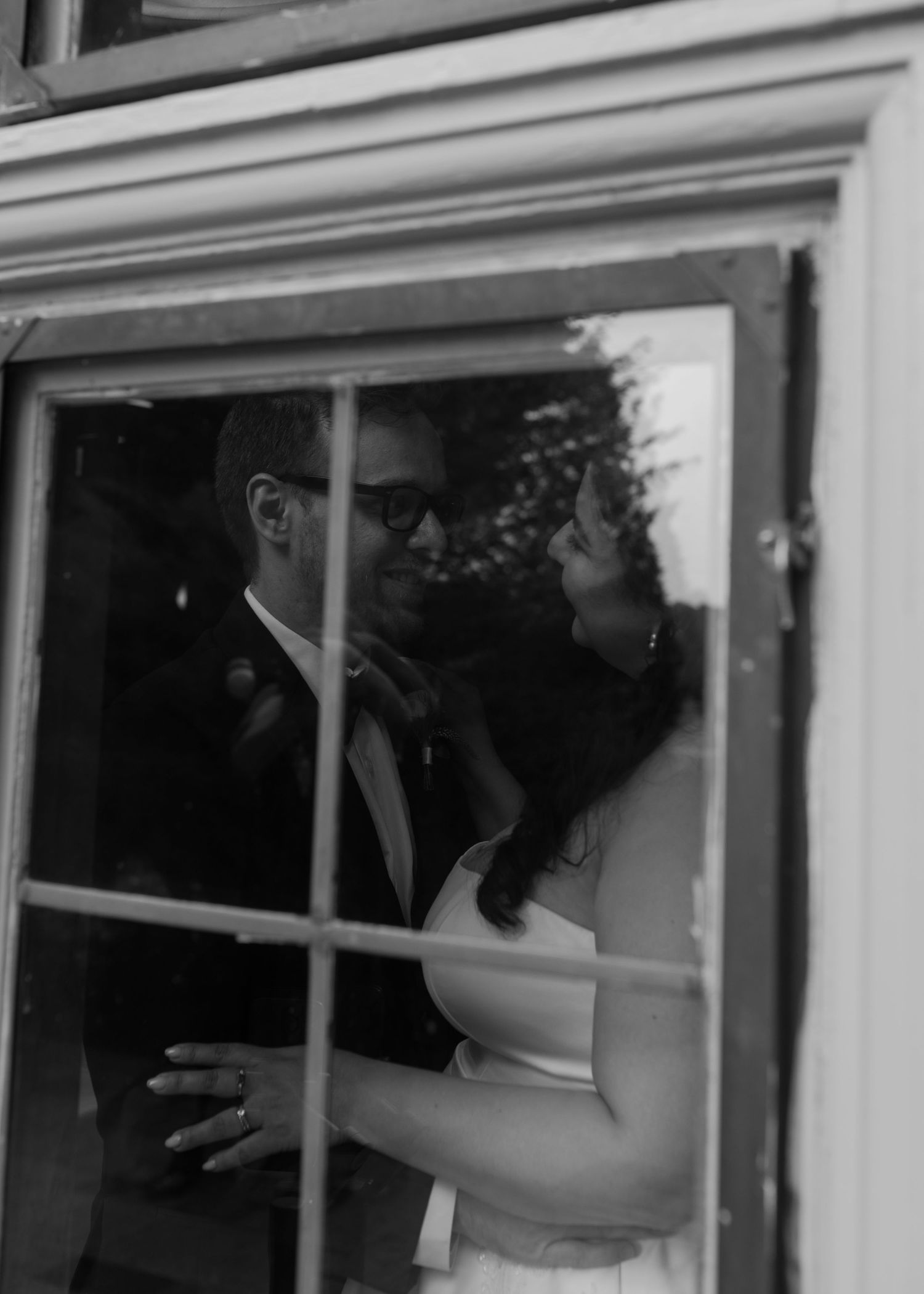 A series of black and white photographs showing someone jumping in sequence through window frames.