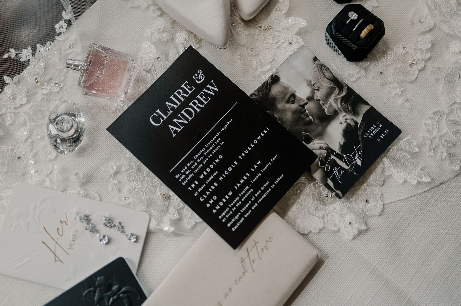 Black book titled Classic Authors on a white marble surface with lace accents and a camera accessory.
