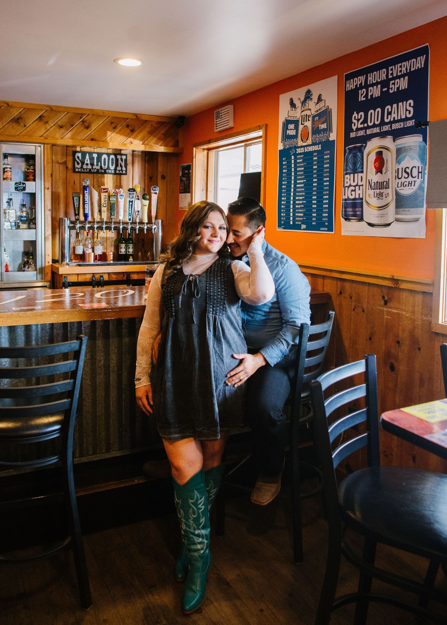 A romantic couple shares tender moments in a cozy restaurant booth with rustic wood paneling and vintage decor.